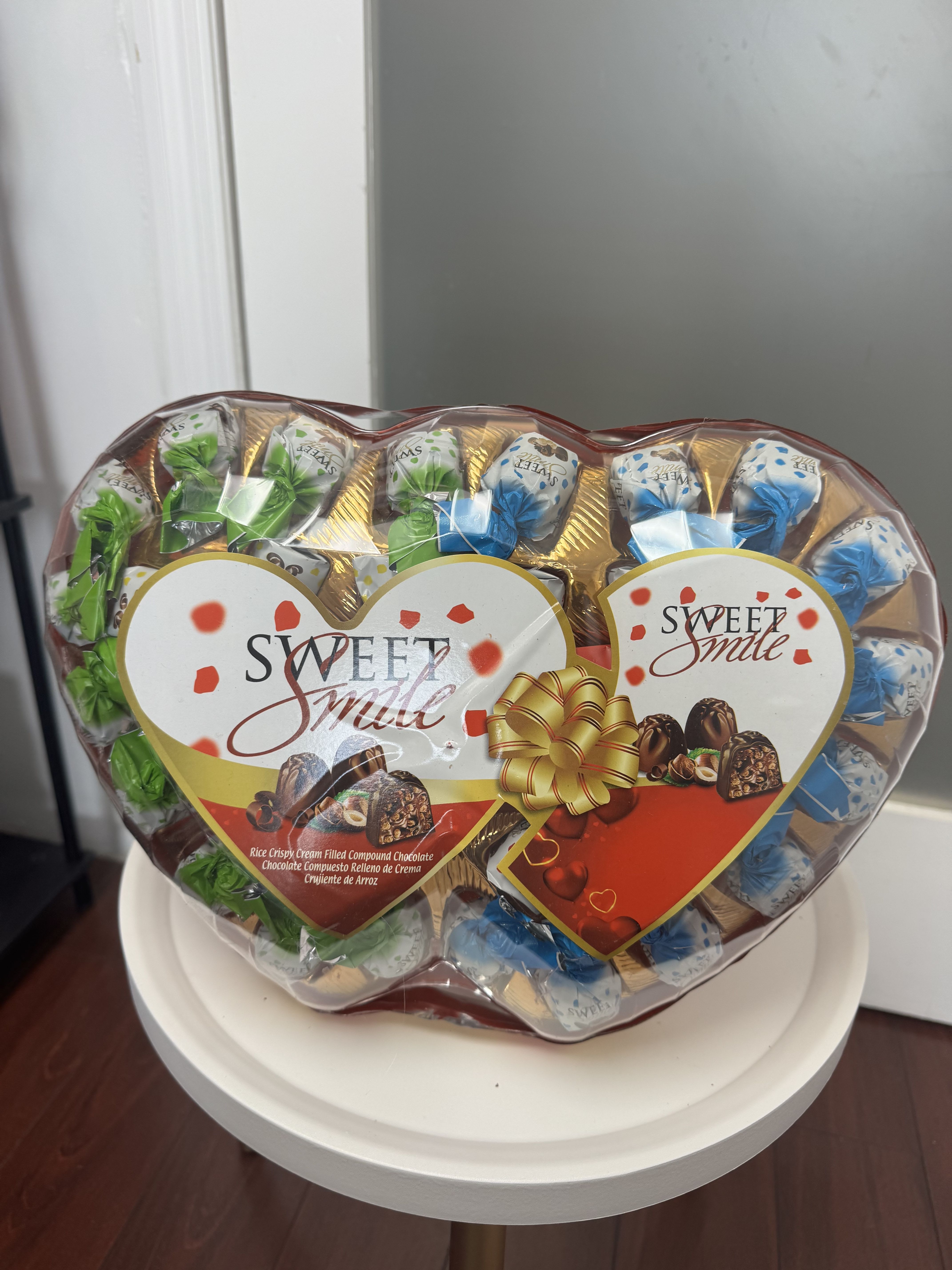 Heart-shaped box of assorted chocolates wrapped in clear plastic
