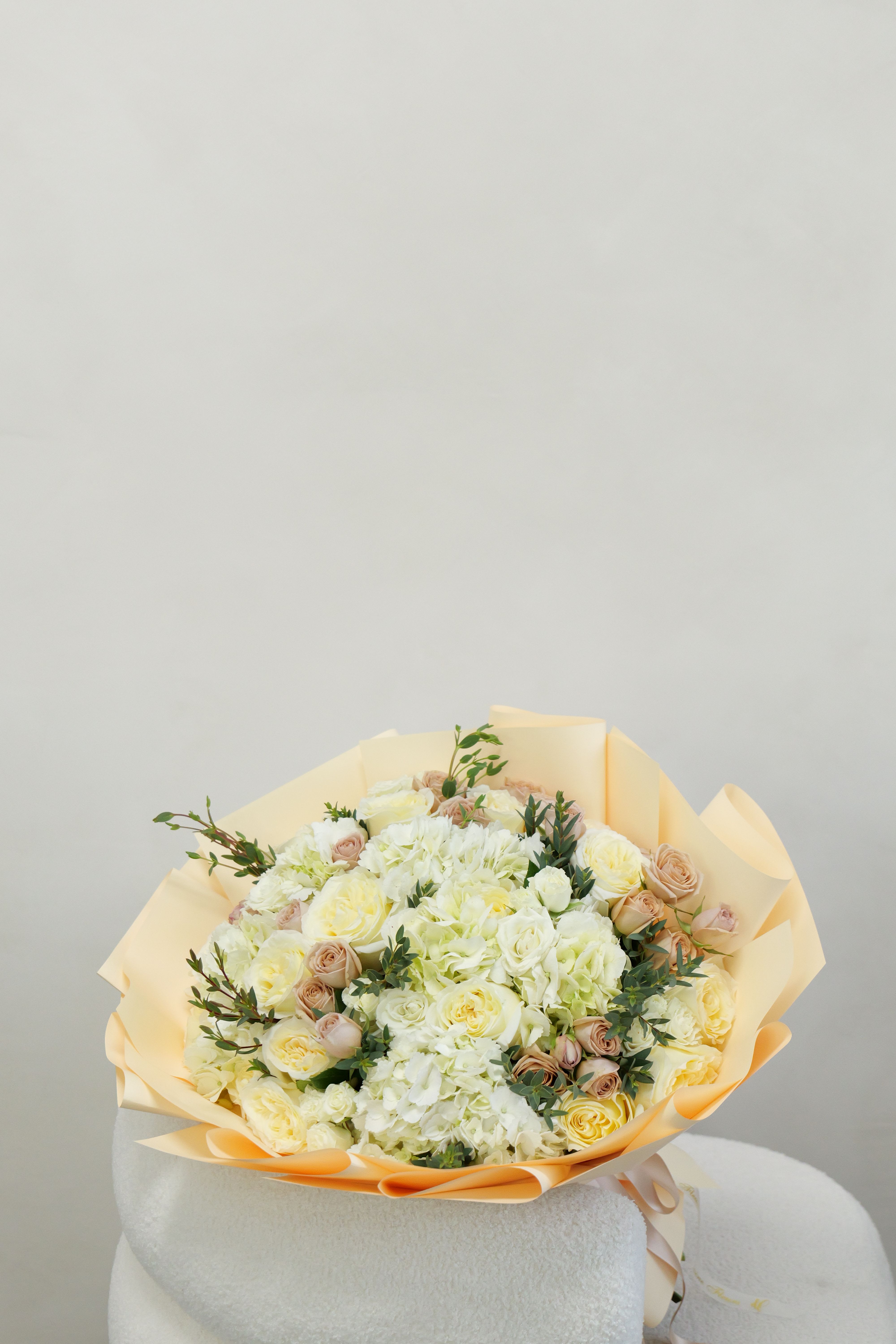 Camila - An elegant bouquet of creamy roses and premium florals, carefully designed to give a soft, luxurious feel that’s perfect for any special moment.