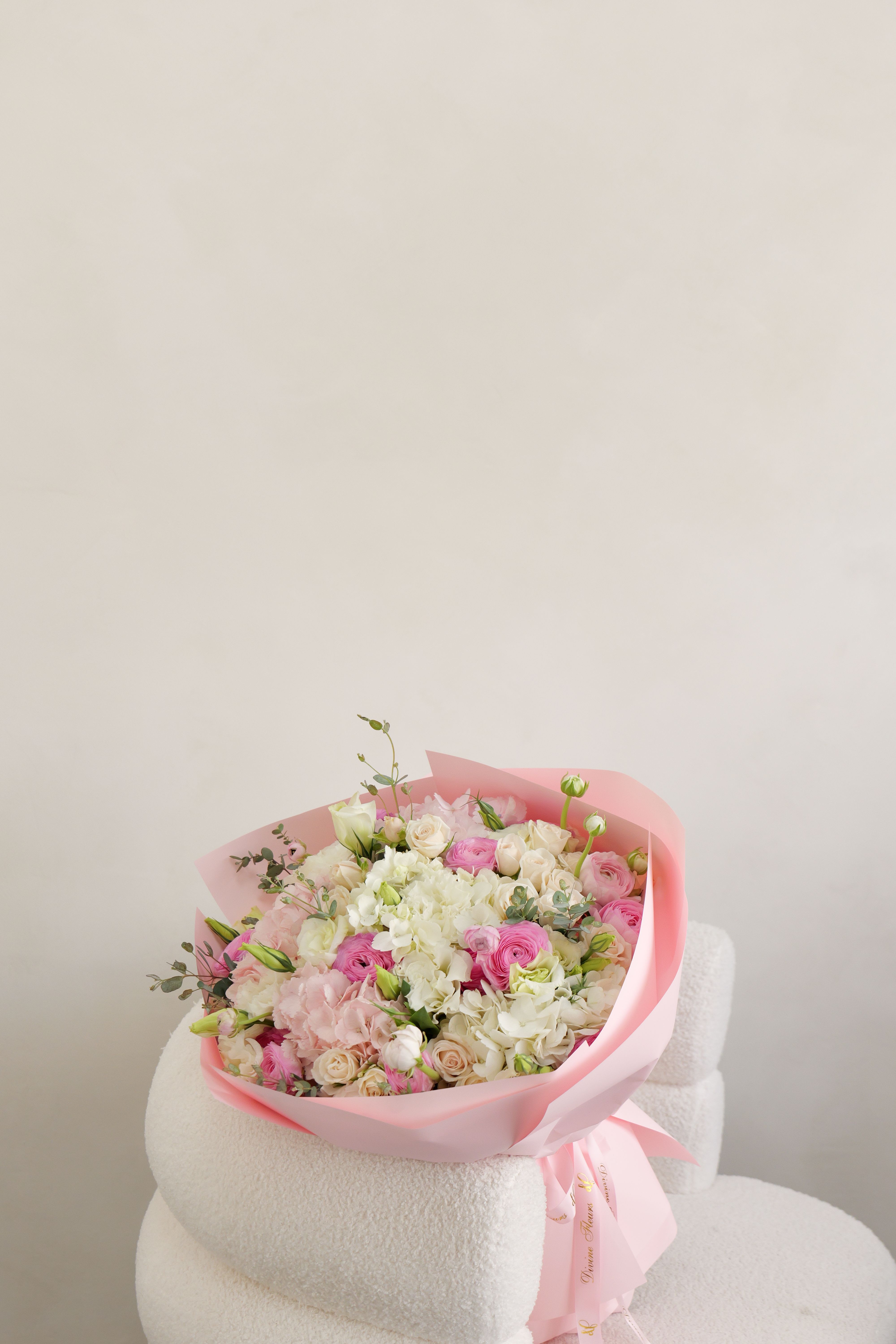 Emilia - A dreamy bouquet filled with soft pink blooms and fresh seasonal flowers, styled to capture a romantic, light, and effortlessly elegant aesthetic. Available in: Standard | Deluxe | Premium Pictured: Deluxe size