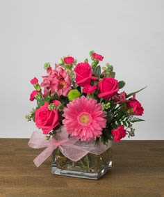 Passionate Pink  - A pink lovers dream with gerber daisy, hot pink spray roses, alstromeria, green Kermit buttons and hot pink minis in a cube vase.  A pink ribbon for that final touch!