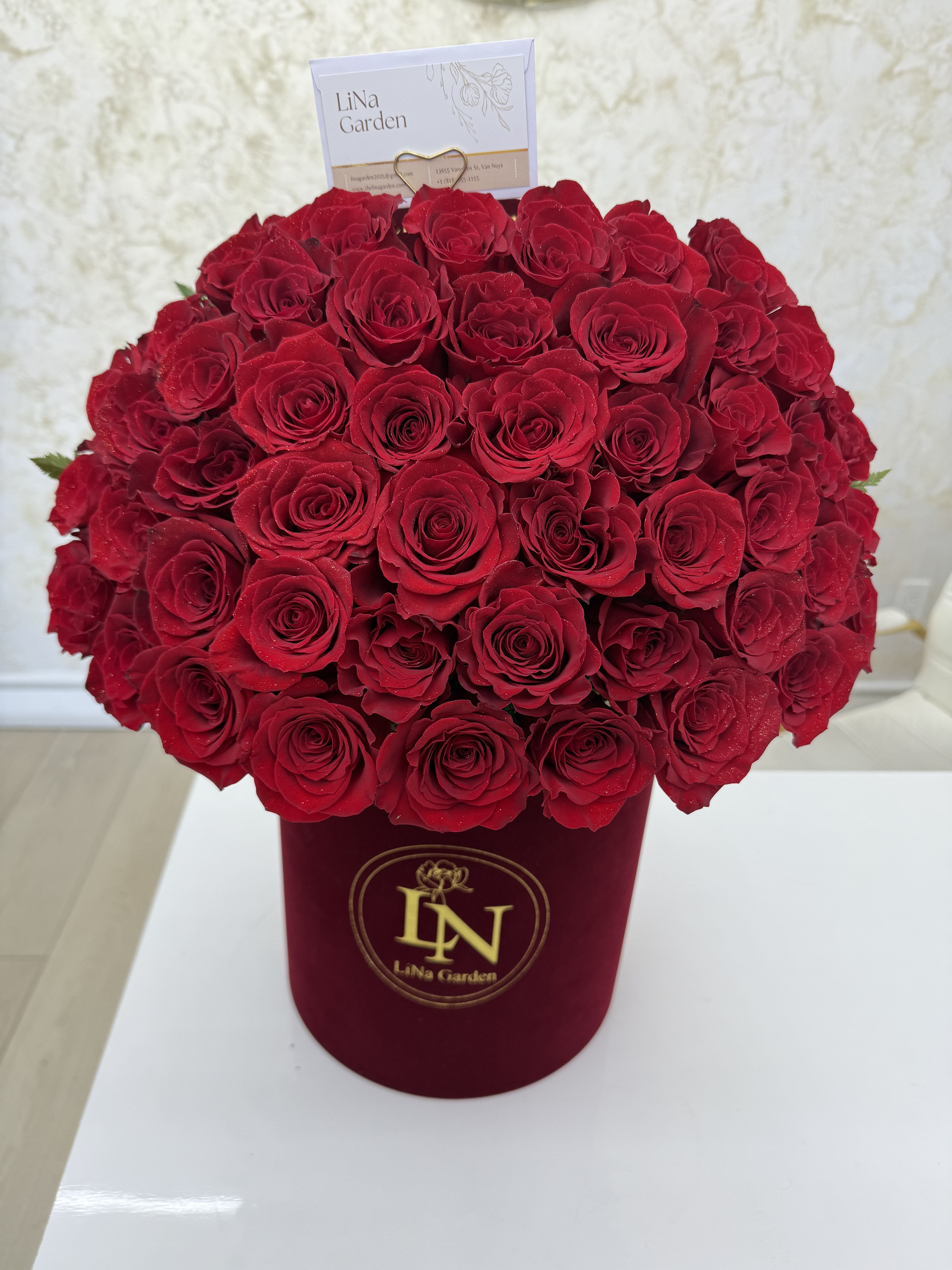 Large bouquet of red roses in a burgundy box