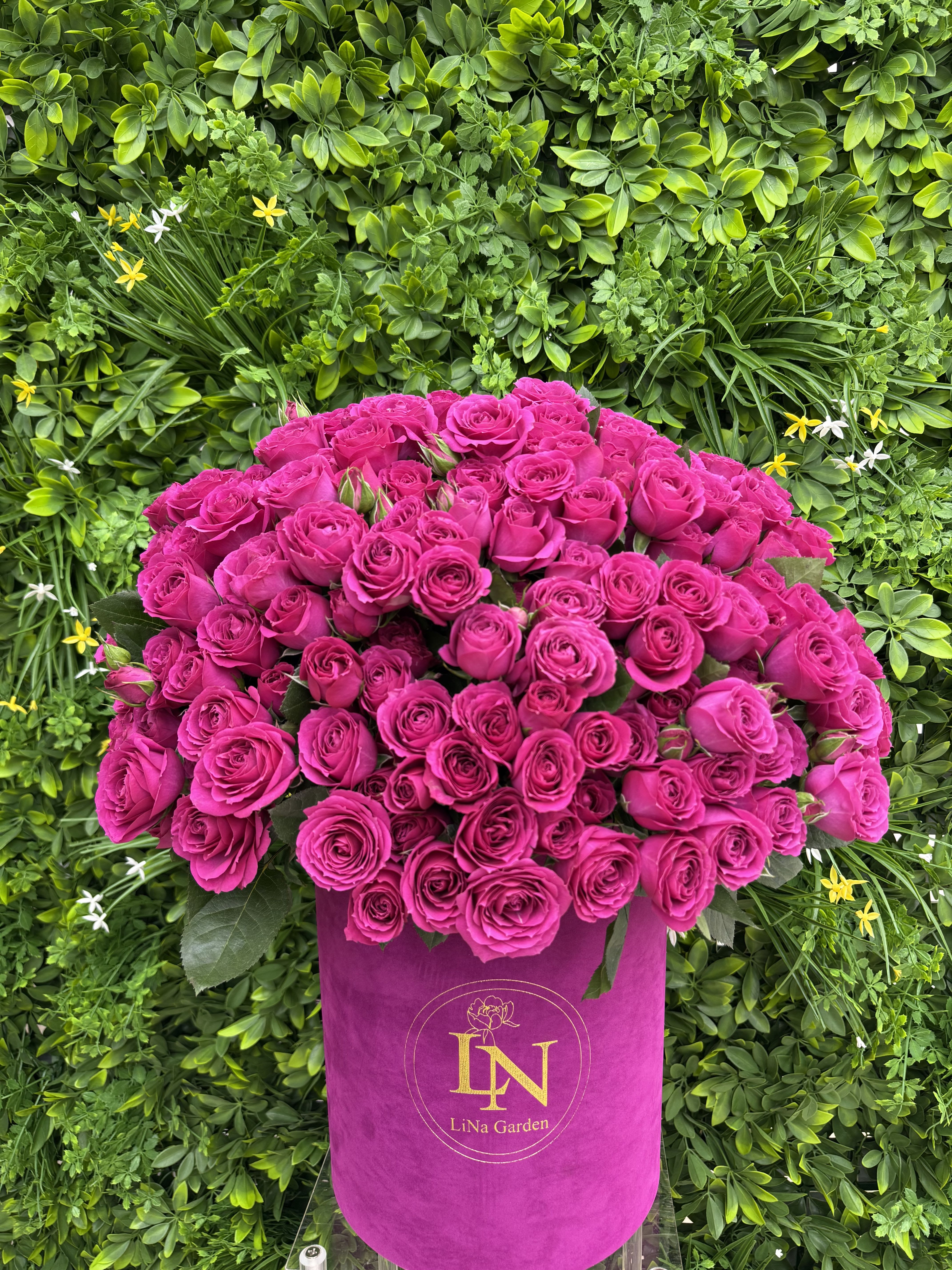 Large bouquet of hot pink roses in a magenta hatbox