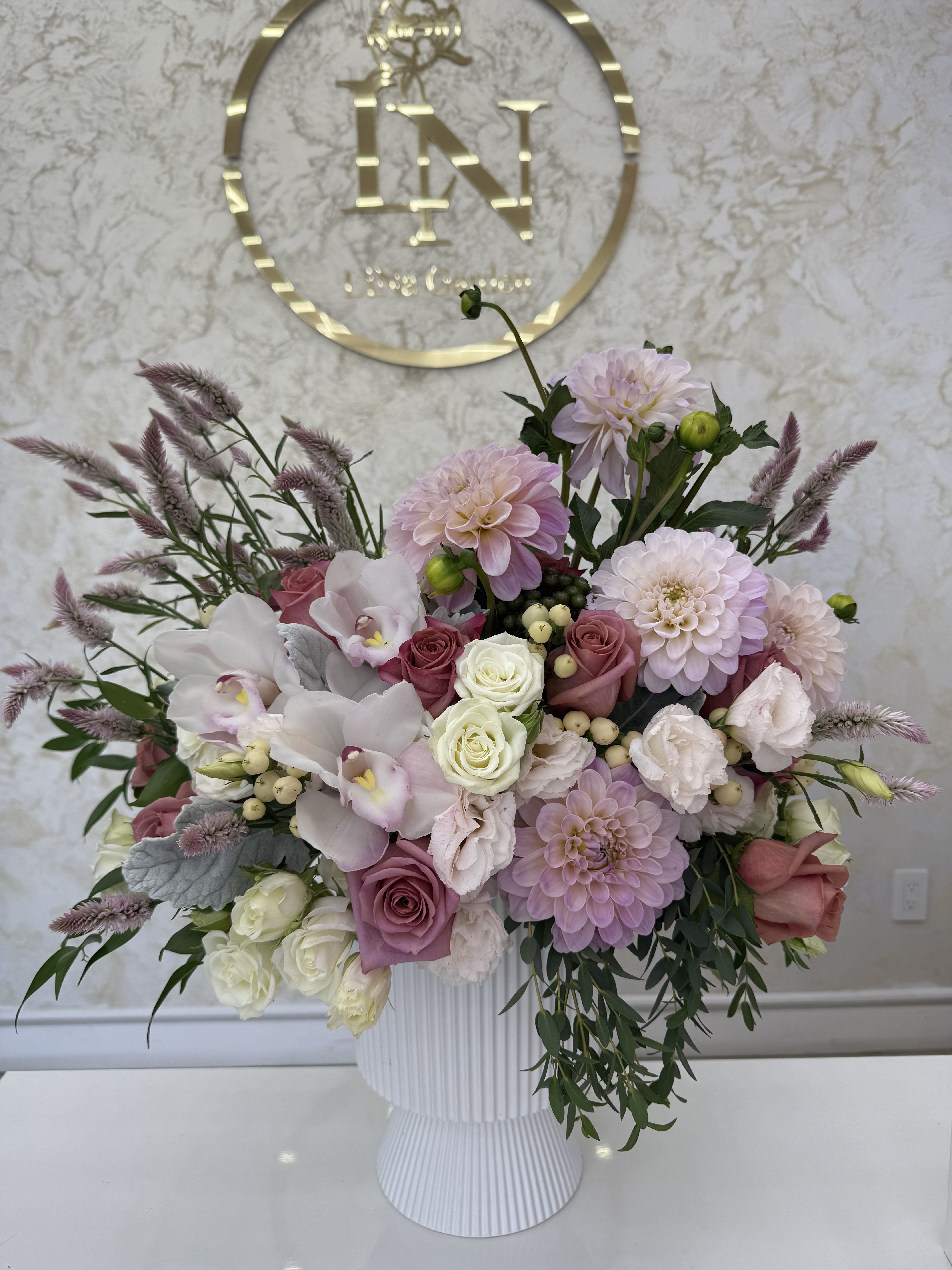 Pink and white floral arrangement in a white vase