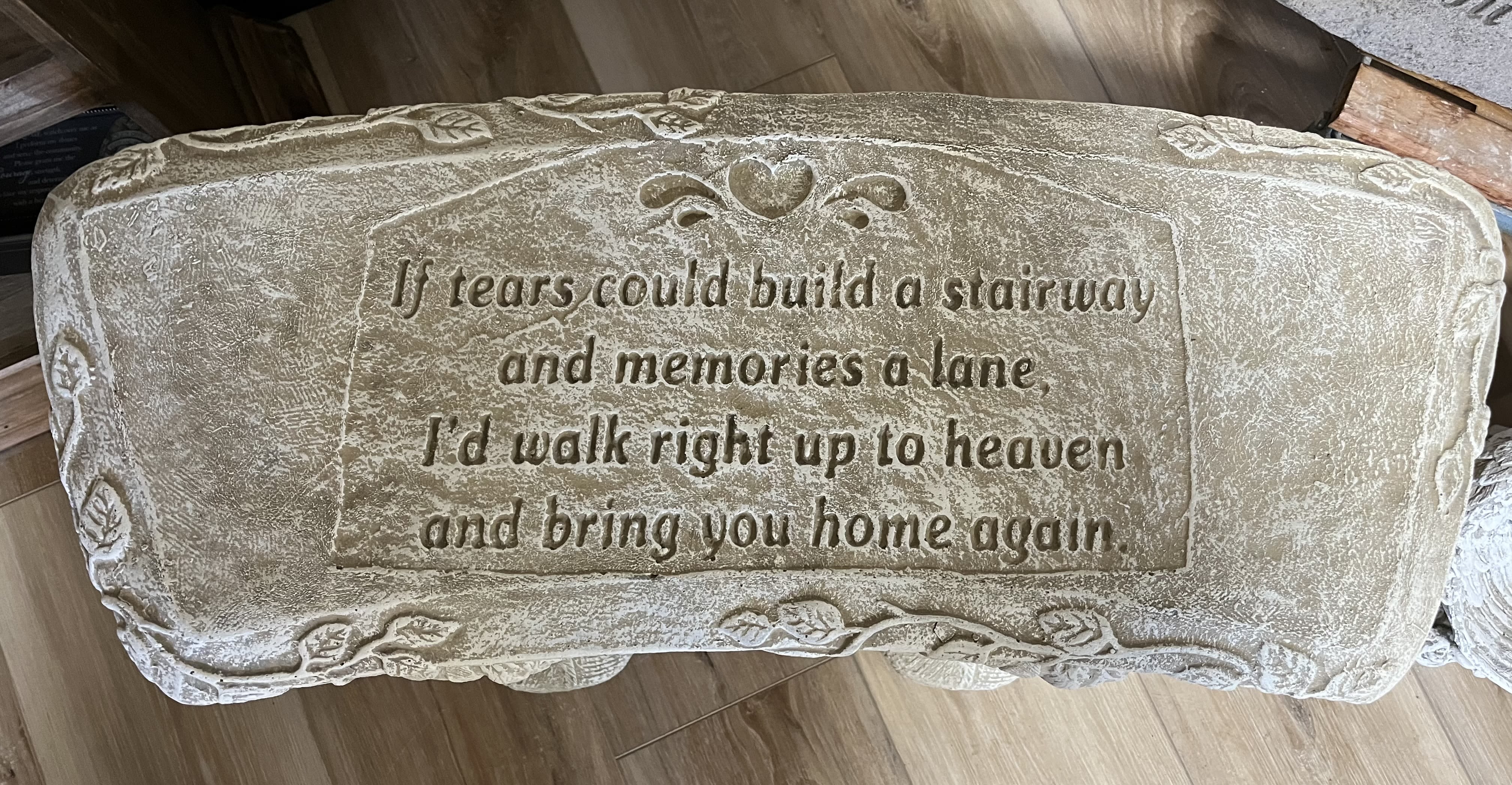 Stone memorial bench with engraved sympathy verse and heart detail