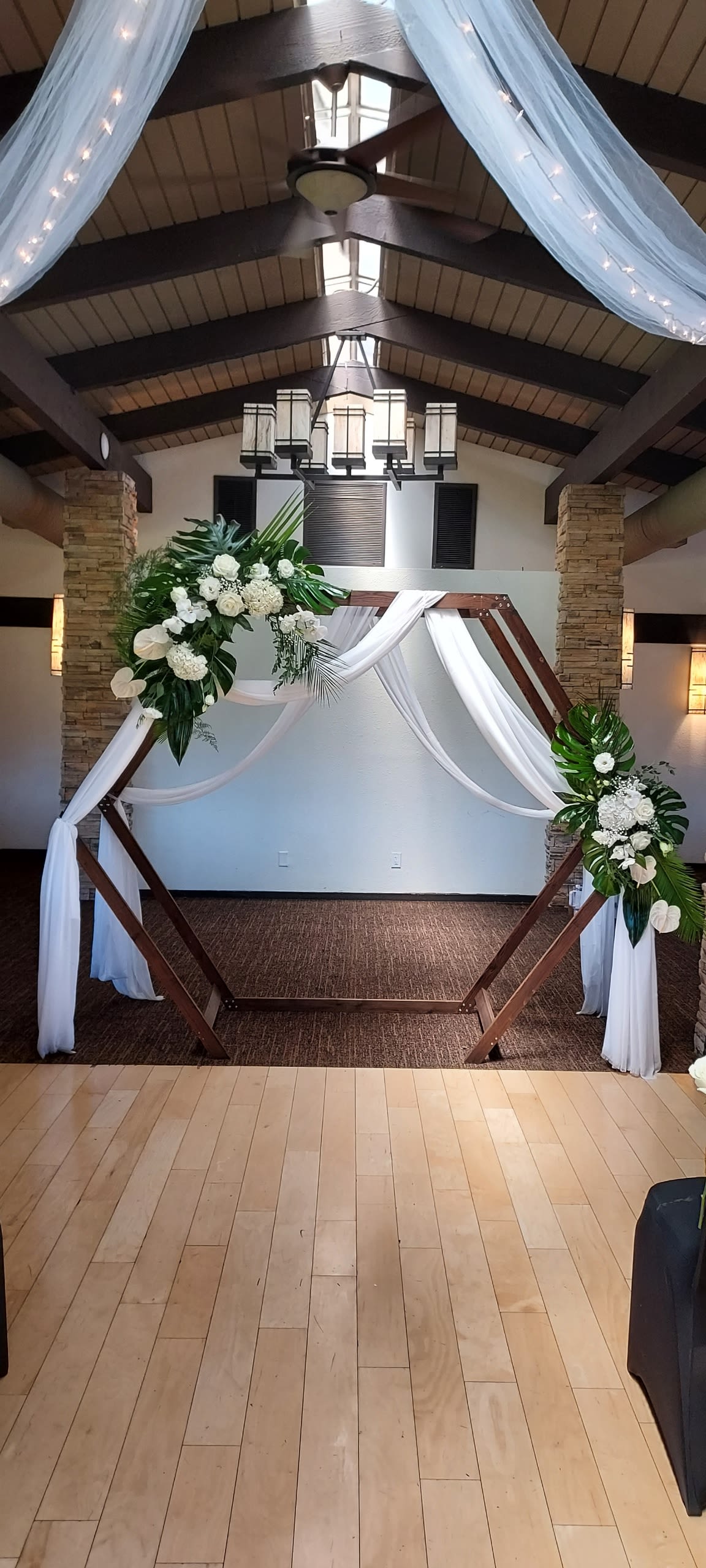 Tropical Wedding Arches  - White and green wedding arches adorned with dendrobium orchids, roses, hydrangeas and tropical foliage for an elegant, fresh ceremony backdrop