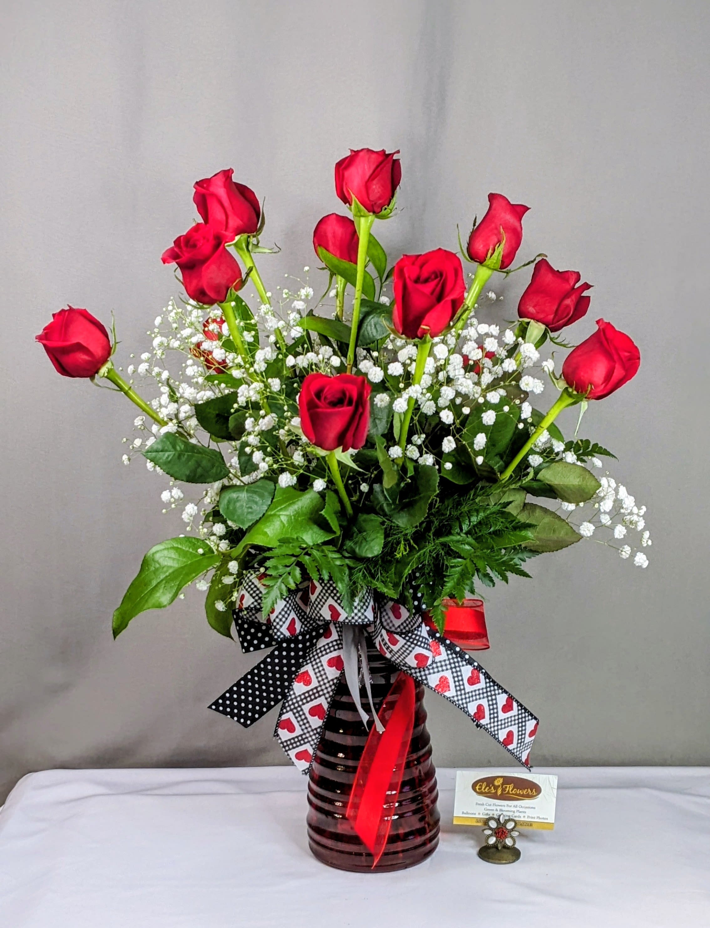 Passionate Roses  - Indulge in classic beauty with our Passionate Roses arrangement, featuring one dozen premium roses artfully arranged in a vase with lush fresh greenery and delicate accent flowers. Whether it's a romantic gesture, a heartfelt gift, or a stunning décor piece, this breathtaking bouquet adds grace and charm to any setting. Handcrafted with care, it's a timeless expression of love, appreciation, and celebration. Many color options and combinations available. Shown in all red or pink and red.   Perfect for anniversaries, birthdays, or just because!   STANDARD PRICE: ONE DOZEN (12) LONG STEM ROSES, ACCENT FLOWERS, GREENERY ALL ARRANGED IN A VASE.  DELUXE PRICE: ONE DOZEN (12) LONG STEM ROSES, ADDED FLORAL BLOOMS (like carnations, alstroemeria, lisianthus, daisies, lilies, tulips etc.) , ACCENT FLOWERS, GREENERY ALL ARRANGED IN A VASE.  Approximate Dimensions: 29"H x 25"W