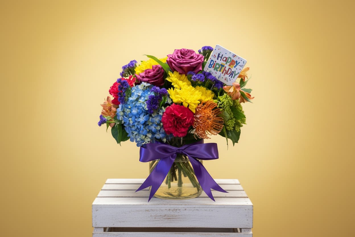 Birthday Blast - Wish someone you love with this Happy Birthday Floral arrangement.  This bold &amp; beautiful bouquet full of vibrant colors! You'll brighten their day in more ways than you'll know as they sit and admire this wonderful gift.  approx dimensions : 12 in W X 16 in tall