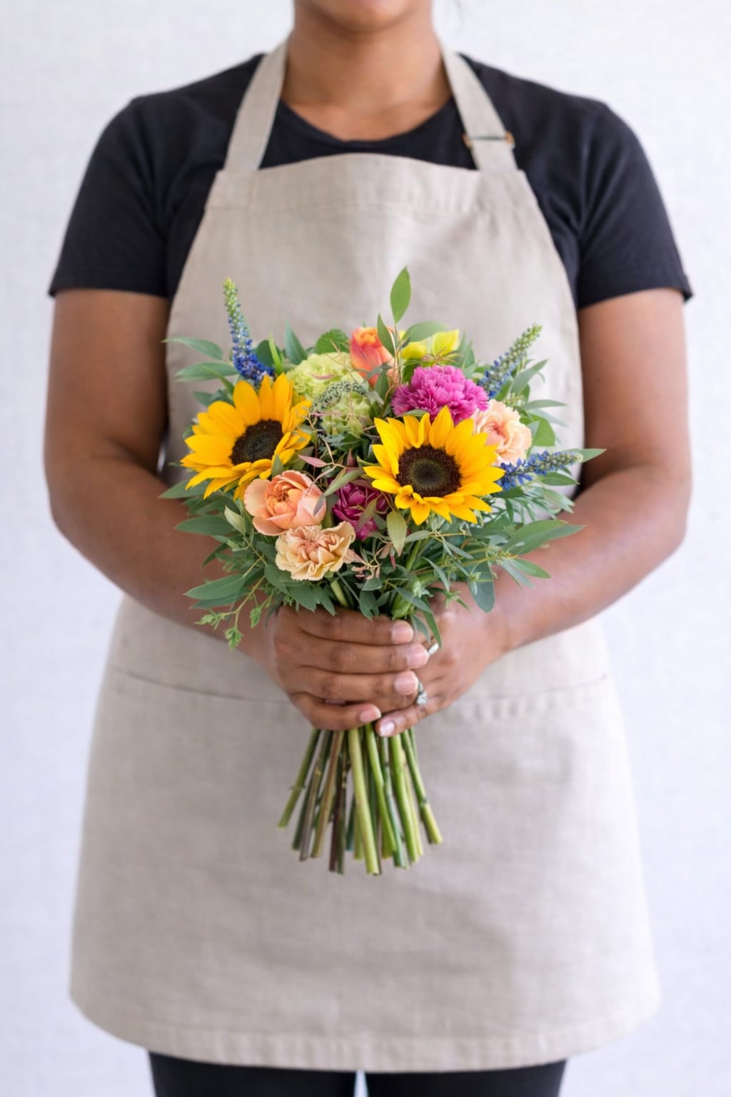 Signature Designer's Choice - Let our designers create a beautifully curated arrangement using the freshest blooms of the season. Each design is uniquely crafted with elegance, intention, and our signature touch.  Our Signature Designer’s Choice begins with a thoughtful, airy design, with options to upgrade to a fuller and more abundant arrangement.   Our Deluxe option offers a more enhanced, lush presentation.  Our Premium option is our most popular, featuring a fuller, more luxurious design with added blooms and texture.  Perfect for any occasion when you want something beautiful, meaningful, and unforgettable.  Vase included.   