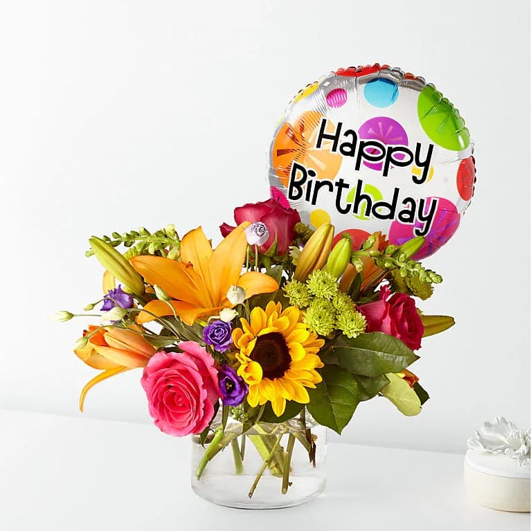 Best Day Bouquet with Birthday Balloon - Celebrate their special day with a vibrant, handcrafted bouquet full of colorful blooms, designed to make their birthday even more memorable. It’s finished with a festive birthday balloon for the perfect touch. The Deluxe Bouquet measures approximately 15" H x 16" W. It is professionally arranged by florists and arrives ready to display. A birthday balloon is included. For longer-lasting blooms, change the water daily and trim the stems every couple of days. Pet Safety Note: Some flowers and greenery in this arrangement may be toxic to pets, so please keep it out of their reach to ensure their safety.