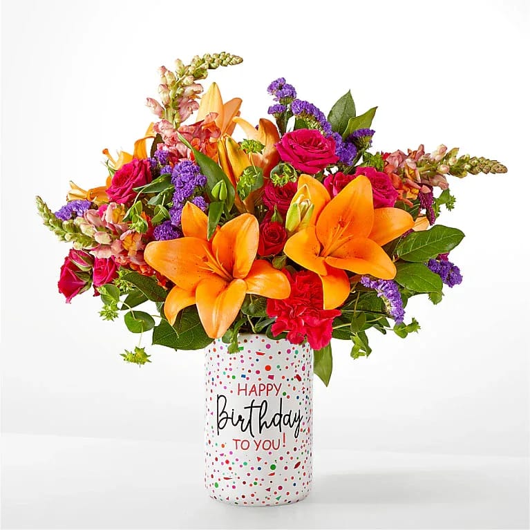 Birthday Palooza Bouquet - Bright, colorful, and full of celebration, this Birthday Palooza Bouquet is designed to make their day unforgettable. Featuring vibrant shades of hot pink, purple, red, and orange, it’s thoughtfully arranged by a local florist in a keepsake vase. The Deluxe Bouquet measures approximately 18" H x 17" W. It is professionally arranged by florists and arrives ready for display. To keep the flowers fresh longer, change the water daily and trim the stems every couple of days. Pet Safety Note: Some flowers and greenery in this arrangement may be toxic to pets, so please keep it out of their reach to ensure their safety. 