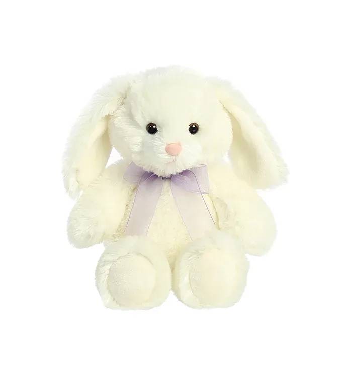 Cream-colored plush bunny with floppy ears and a light purple ribbon bow.