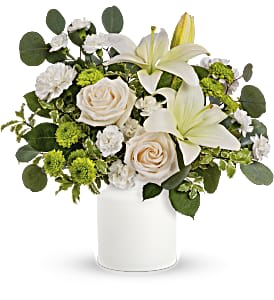 Eternally Elegant  - This ethereal arrangement is a calming, peaceful gesture that shows them you care. Elegant white blooms accompany a timeless white vase. Roses, white lilies and carnations are accented with leaves of fragrant and calming eucalyptus.