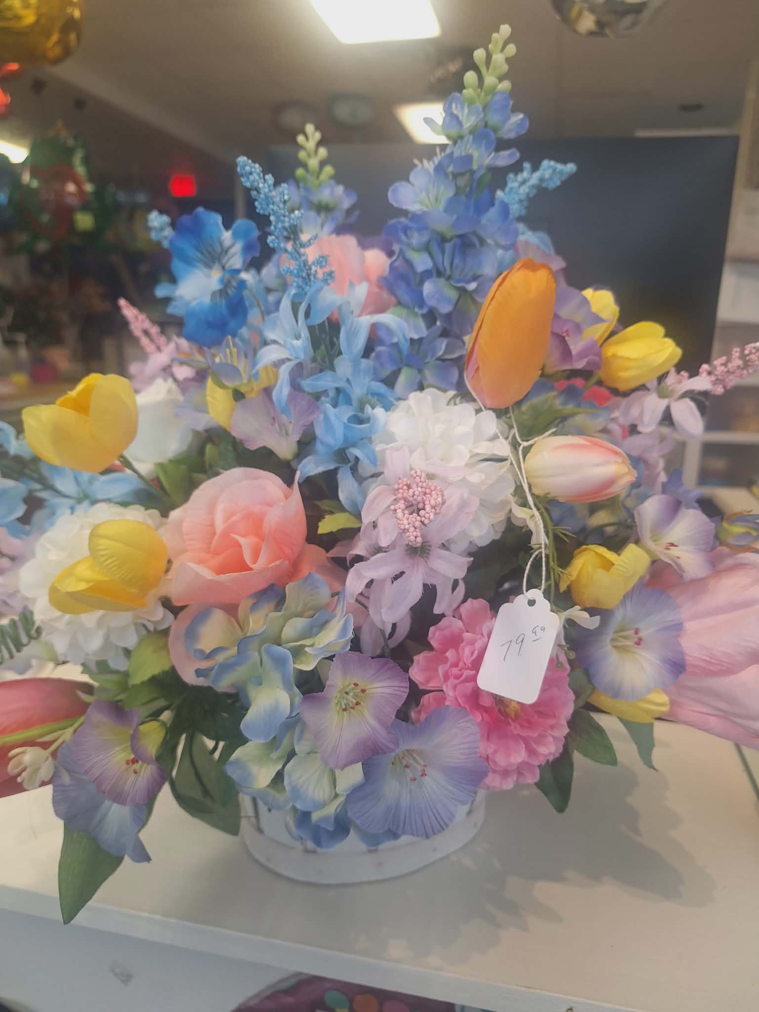 Silk arrangement of pastel tulips and mixed flowers in a white bowl container
