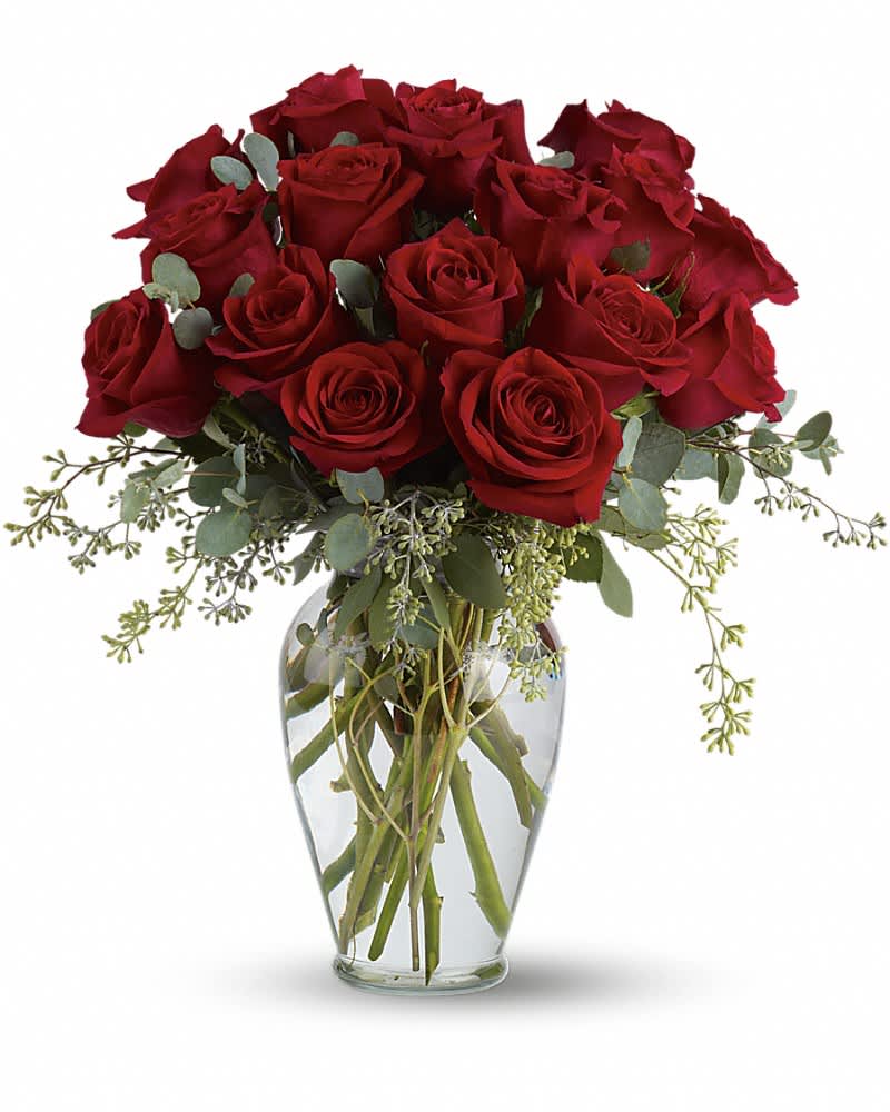 Arrangement of long-stem red roses in a clear glass vase