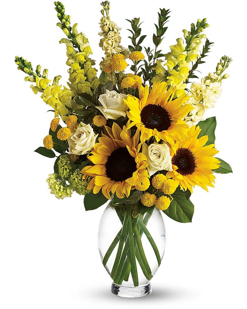 Tall arrangement of yellow sunflowers, white roses, and yellow blooms in a clear glass vase
