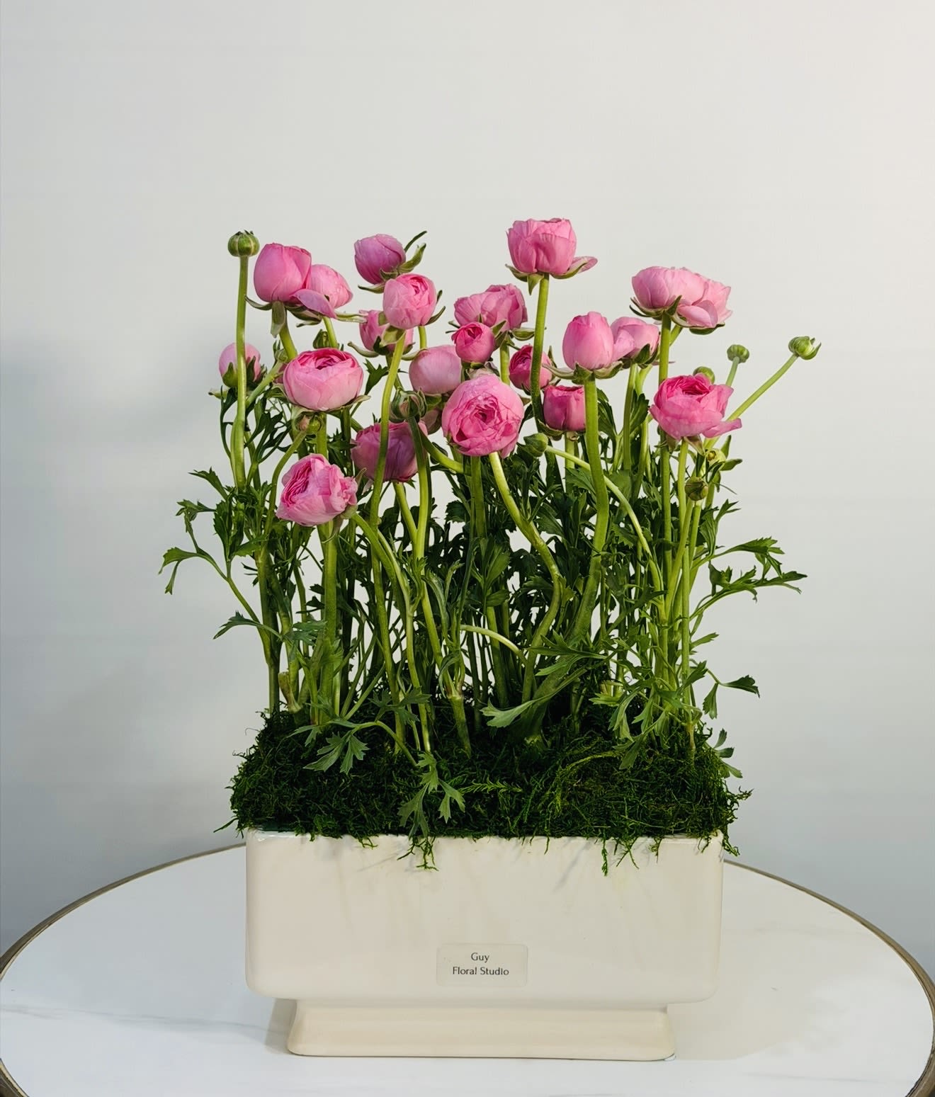 Pink Crush -  A soft yet striking arrangement featuring 20 fresh pink ranunculus, beautifully designed in a modern ceramic planter and finished with natural moss for a clean, garden inspired look. The delicate layers of each bloom create a romantic and airy feel, while the structured design keeps it modern and refined  perfect for gifts, celebrations, or adding a fresh touch to any space. Each arrangement is handcrafted with premium blooms to ensure long lasting beauty and a polished presentation. Same Day Flower Delivery Available across Beverly Hills, Bel-Air, West Hollywood, Beverly Grove, Santa Monica, Culver City, Hollywood Hills, Hollywood.