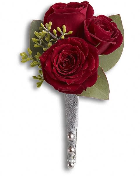Small boutonniere of deep red roses with a silver-wrapped stem and pearl pins