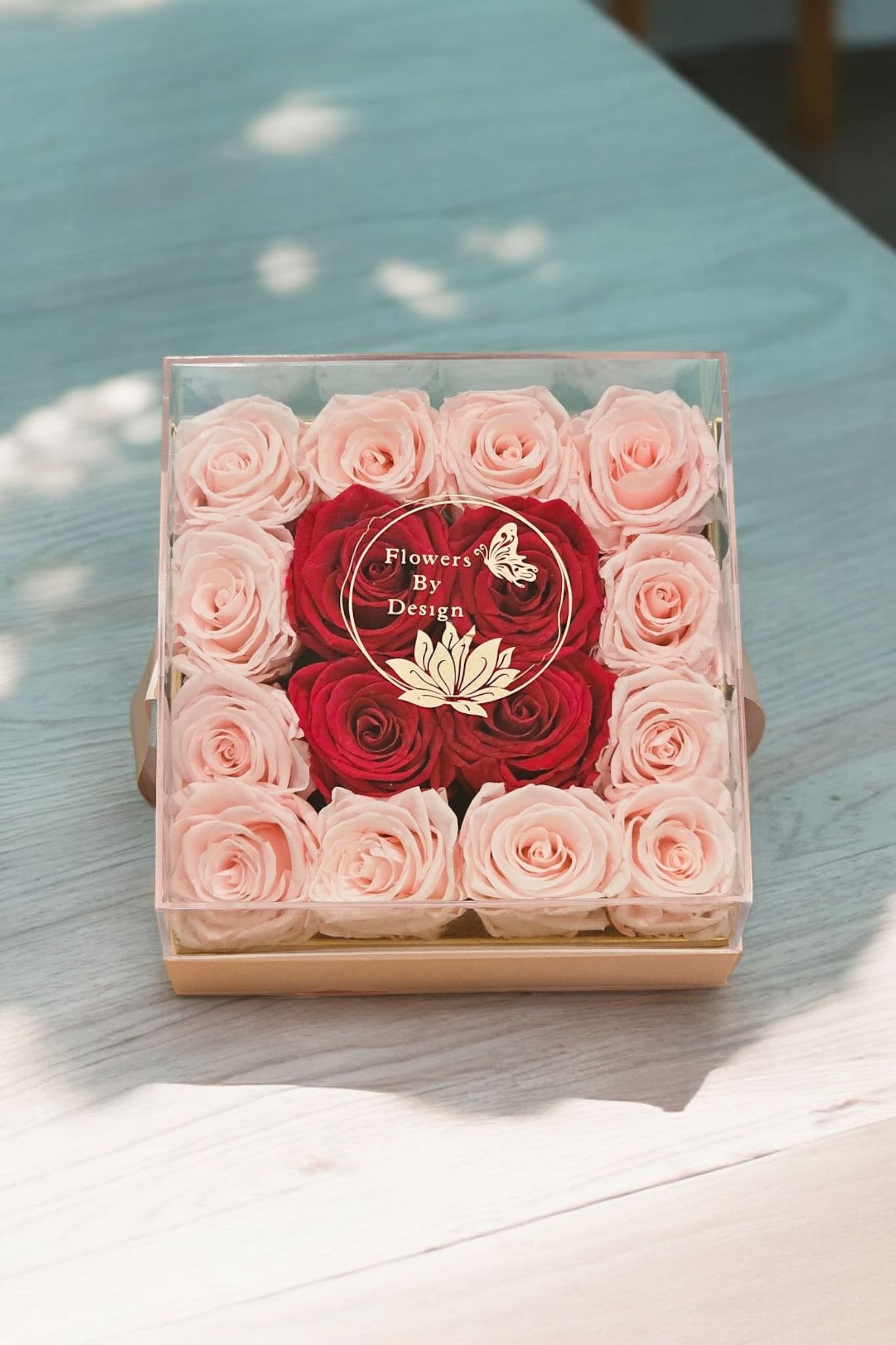 Glamorous Pink Fusion - An arrangement featuring 12 pink preserved roses and 4 hot preserved pink roses presented in a pink delicate deluxe box.&nbsp;The combination of preserved roses in a chic box suggests a luxurious and sophisticated gift