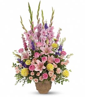 Ever Upward Bouquet - This elegant bouquet, the Ever Upward, is expertly crafted with a stunning array of pink gladioli, lilies, roses, and spray roses, as well as purple lakspur, stock, and yellow cushion. The beautiful combination of colors and textures is complemented by fine greenery, making it the perfect choice for any occasion.