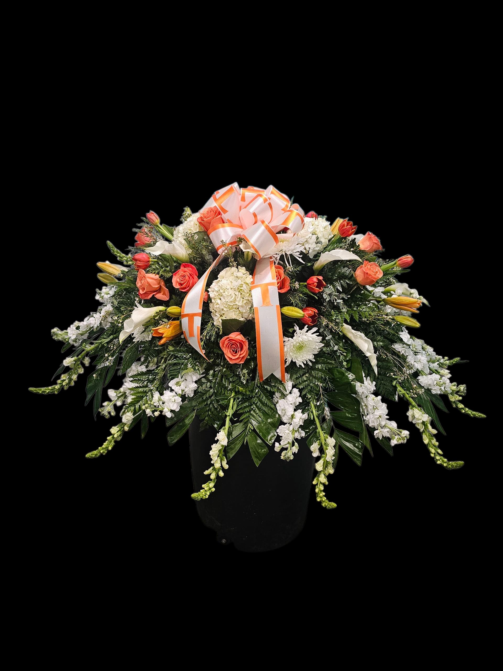Loving Remember Casket Spray - This loving memorial casket spray is the perfect way to honor your loved one. Featuring the vibrant colors of Tennessee University State, it is handcrafted with mini white callas, white stock, white hydrangeas, and a variety of orange flowers. Accented with fine greenery and fillers, this spray is a beautiful and meaningful tribute.