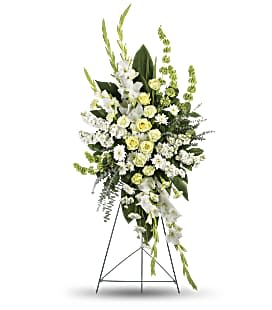 Magnificent Life Spray - Experience the magnificence of Life with our stunning Magnificent Life Spray. This beautiful arrangement features delicate white gladioli, bells Ireland, and roses, paired with vibrant green carnations and stock. The addition of green ti leaves, spiral eucalyptus, and lemon leaf adds a touch of elegance and freshness. This spray will bring joy and beauty to any space.