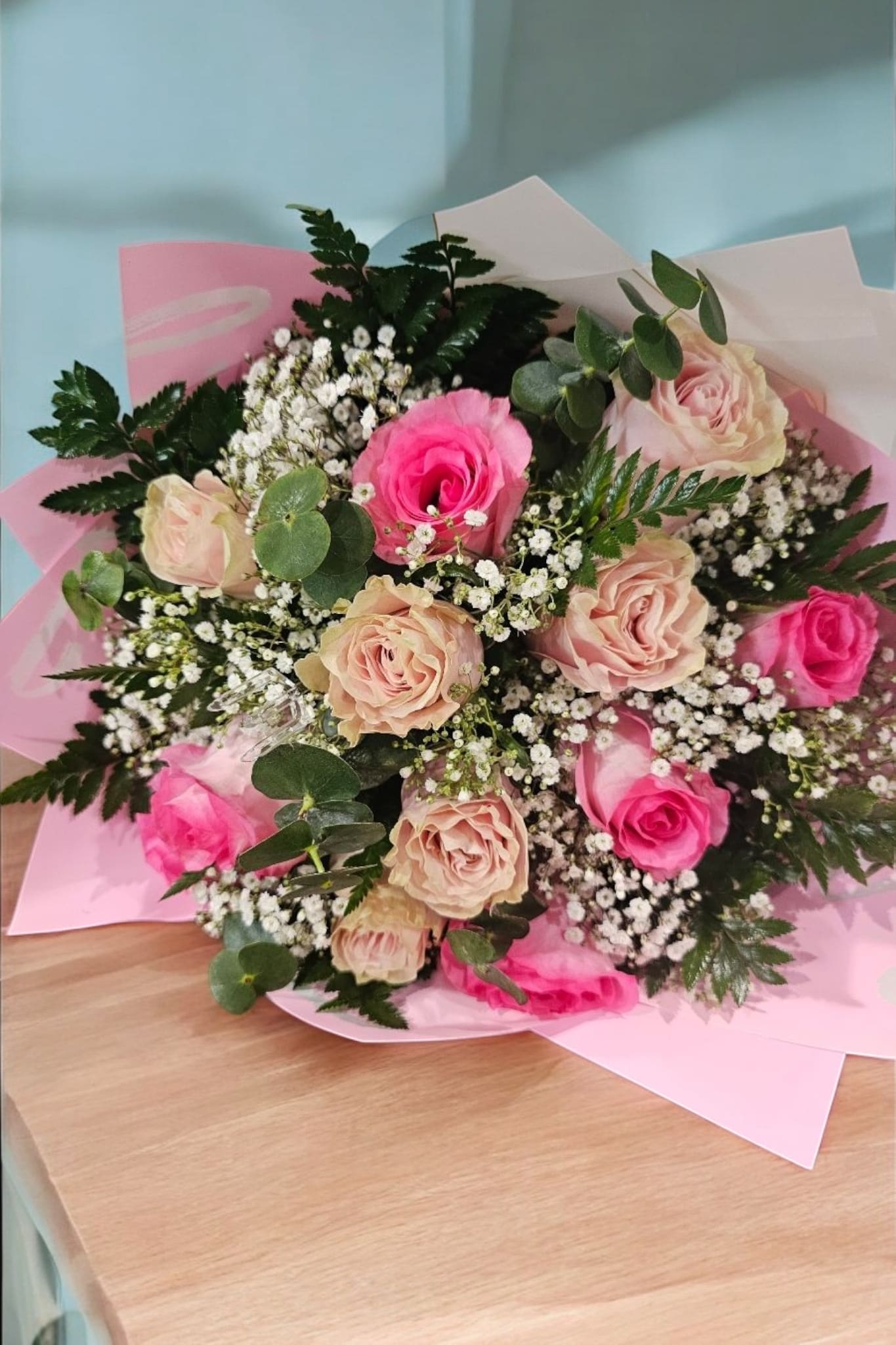 Mix Blush Roses - Enhance any special occasion with the elegant Mix Blush Roses bouquet. This beautifully crafted arrangement features a mix of light and medium pink roses, complemented by fine filler and delicate greenery. Wrapped in elegant paper, these roses will add a touch of sophistication and charm to any setting. Perfect for expressing love, gratitude, and appreciation.