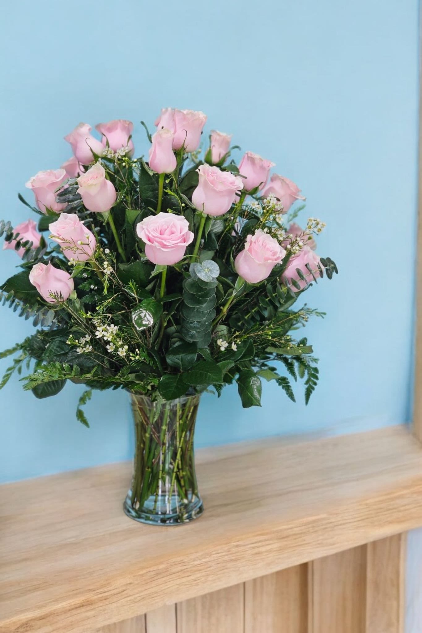 Pink Roses  - An elegant arrangement of pink roses with fine greenery is often referred to as a romantic bouquet" The fine greenery, such as ferns or delicate eucalyptus, complements the soft, romantic feel of the pink roses, adding texture and a touch of natural beauty