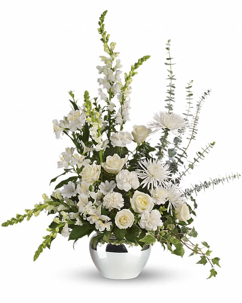All-white flower arrangement with roses, carnations and mums in a shiny round silver vase