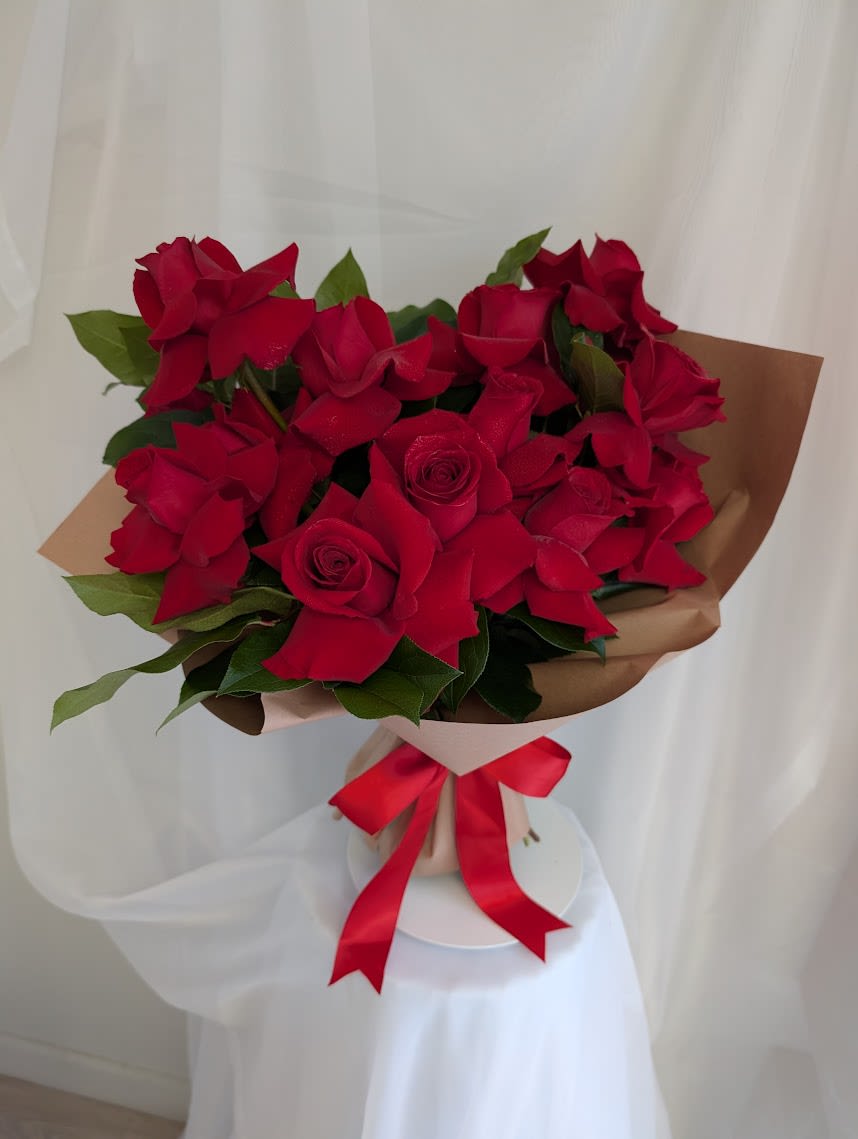 Modern Red Rose Hand Bouquet-One Dozen - The perfect mix of classic and modern. One dozen romantic red roses beautifully wrapped with a red satin ribbon. 
