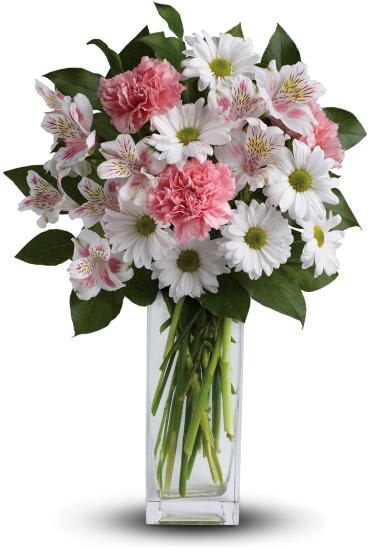 Tall bouquet of white daisies, pink carnations, and white alstroemeria in a clear rectangular glass vase