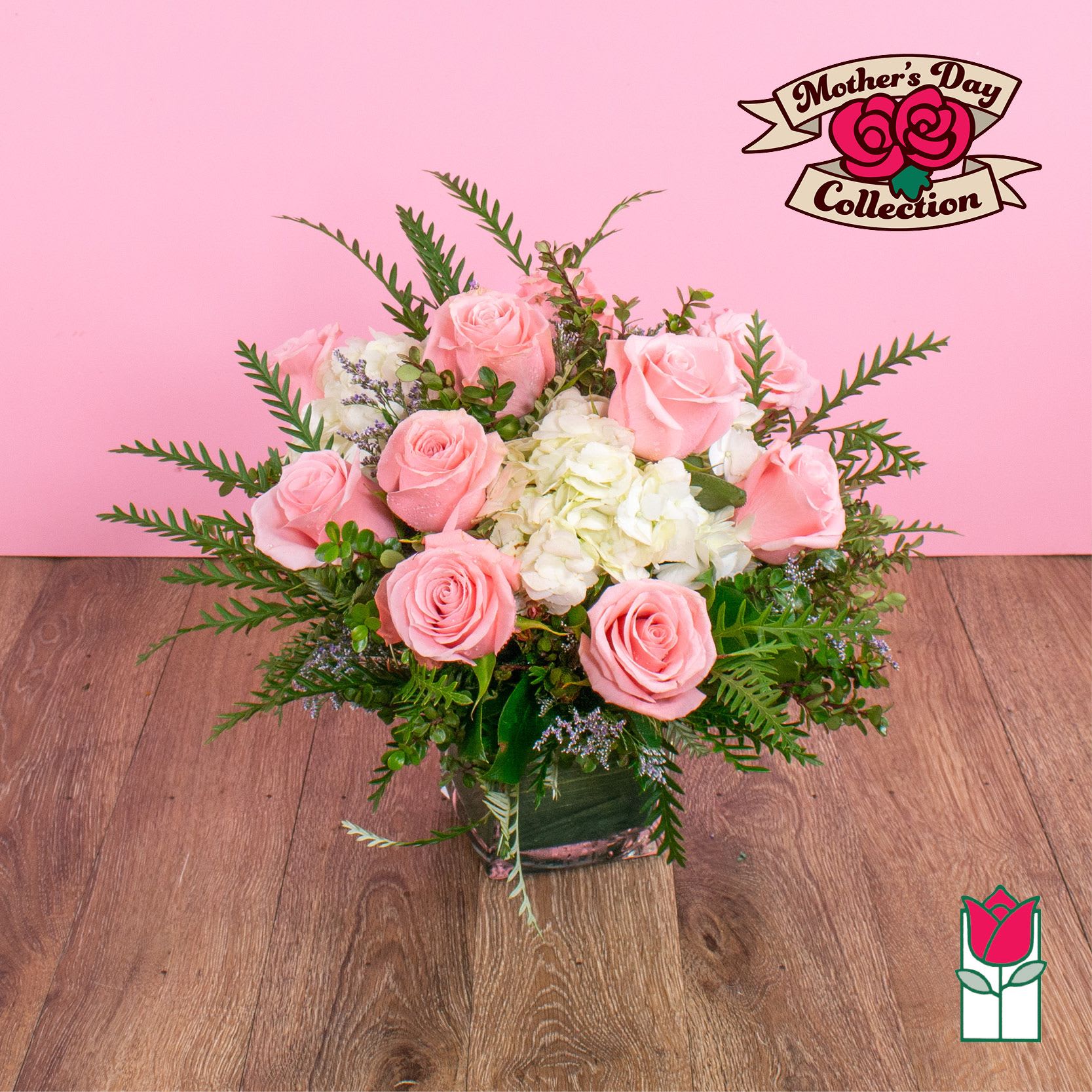 Beretania's Compact Bouquet (Bubblegum) - Elevate your space with the Beretania Florist Compact Bouquet, a charming floral arrangement that effortlessly combines elegance and versatility. Housed in a beautiful 4" glass cube vase, this compact bouquet features a delightful composition of hydrangeas, foliage, and your choice of roses in various colors, allowing you to tailor it to your preferences.  Whether you opt for the timeless allure of red roses, the soft romance of pink, or the vibrant cheerfulness of yellow, each variant of the compact bouquet brings a unique charm to any setting. The meticulous design ensures a harmonious blend of textures and hues, creating a visually appealing arrangement that suits any occasion.  For those seeking an extra touch of sophistication, consider our upgraded option – the Olivia Compact Bouquet. This variant remains true to the original design but introduces the exotic beauty of colorful cymbidium orchid blossoms, elevating the bouquet to a new level of elegance.  Perfect as a thoughtful gift or a stunning addition to your own space, the Beretania Florist Compact and Olivia Bouquets are crafted with precision and care, promising a burst of floral beauty that suits your style and preferences. Choose the color that speaks to you and let the timeless beauty of these bouquets brighten your day.