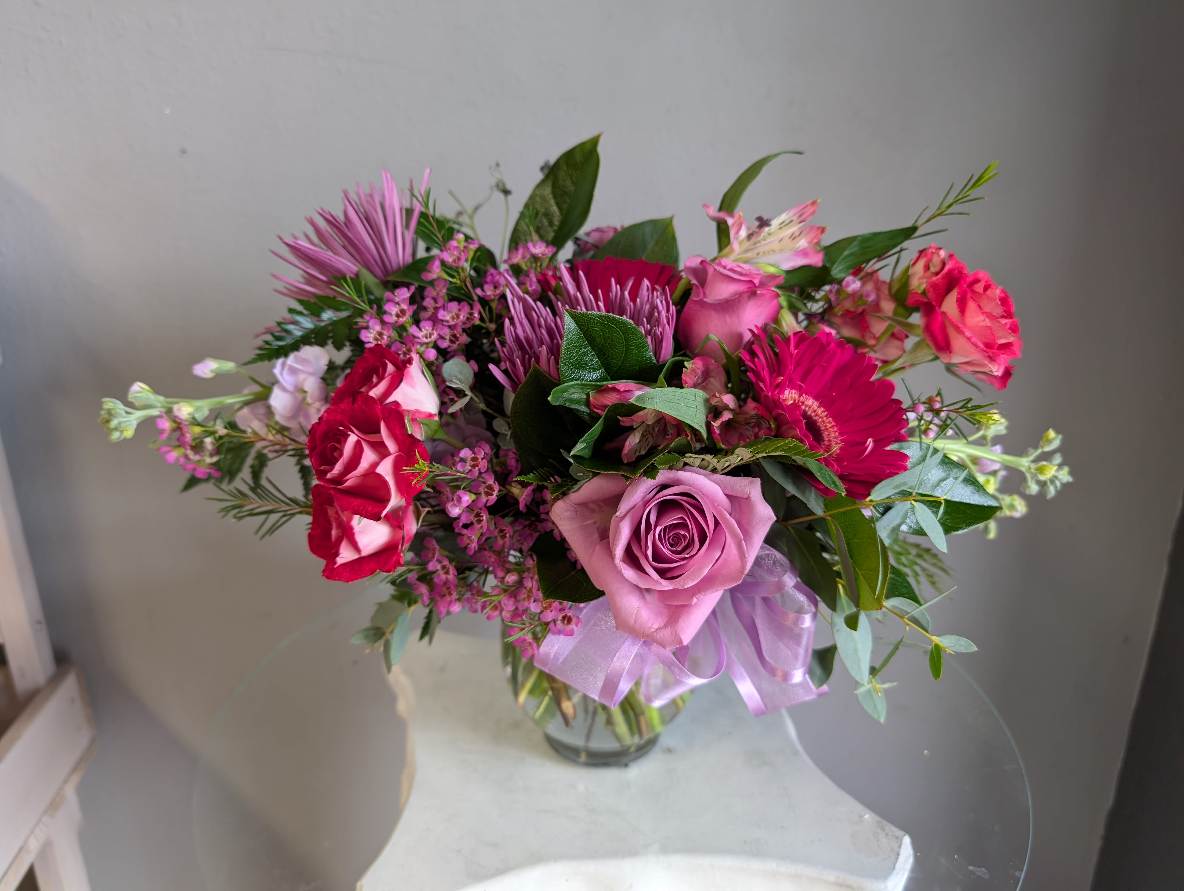 #702 Designer's Choice Vase Arrangement - This beautiful flower arrangement of fresh mixed seasonal blooms is made by local designers in the heart Orange California. Hand crafted and perfect for every occasion, from birthdays and new babies to sympathy and just because. The best choice to show you are thinking of that special someone. Can be sent as a local delivery or in-store pickup. This is an original, one of a kind arrangement. Order now before it's too late!  UPGRADES: All upgrades are applied at the designer’s discretion and fulfilled to value using the freshest seasonal and/or premium flowers available. Container upgrades may be included when possible; otherwise, value is reflected in the floral selection while maintaining the original design style.