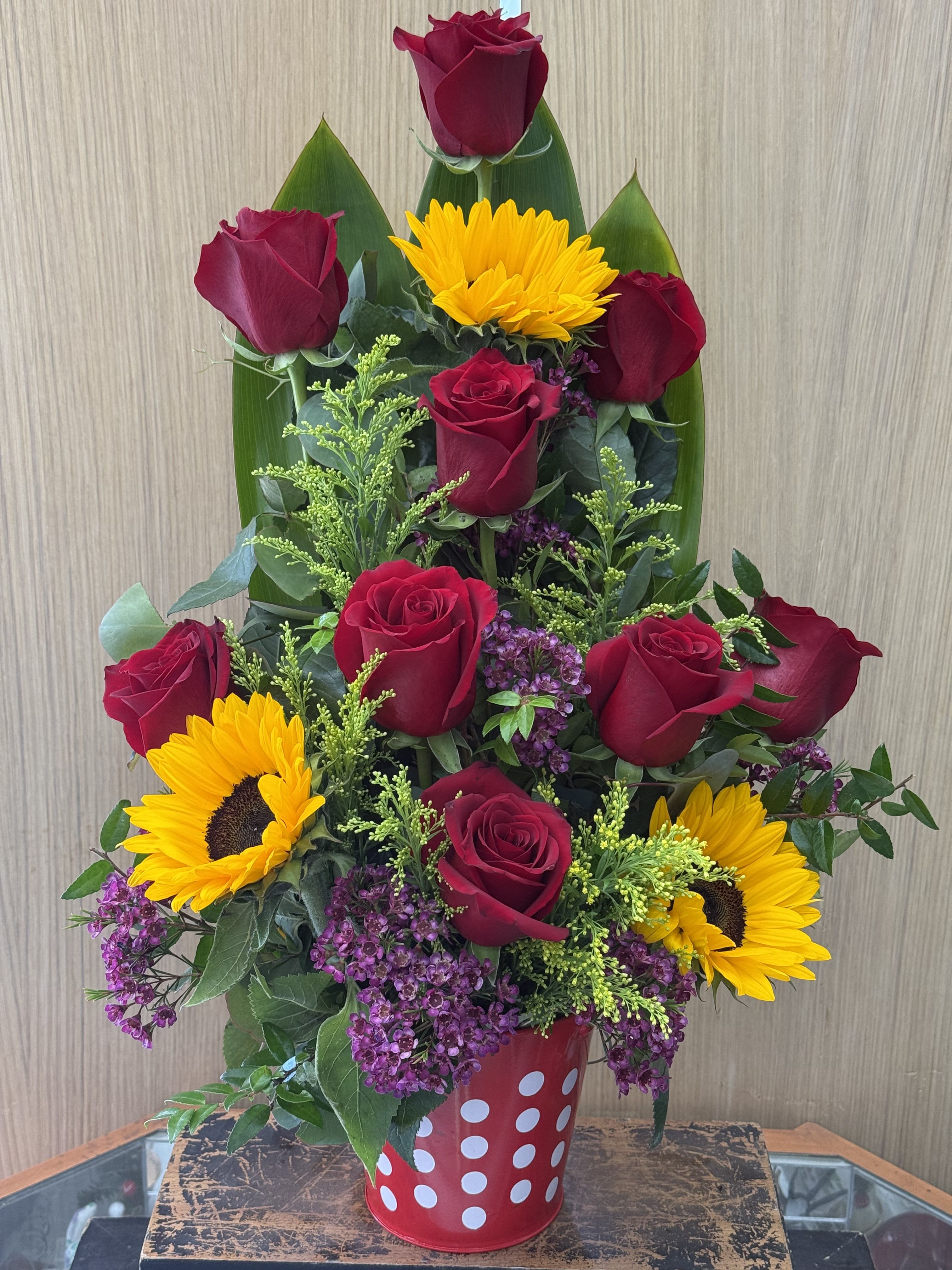 Sunshine Bucket - Ecuadorian roses with sunflowers arranged in a decorative tin bucket (color may vary based on availability). 