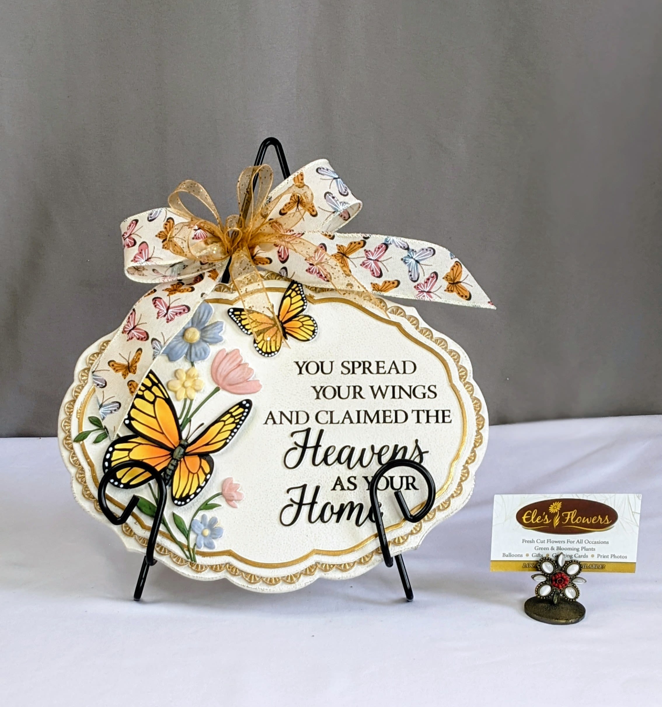 Sympathy Stone - Heavens Home - A sympathy stone is a heartfelt memorial gift, crafted from durable resin. Engraved with comforting words, symbols, and images, it serves as a lasting tribute to a loved one, providing solace during times of grief. Perfect for gardens, memorial areas, or indoor displays, this stone is a meaningful reminder of love, loss, and cherished memories.  This stone has the phrase, "You spread your wings and claimed the Heavens as your Home." Stand included.  Approximate Dimensions: 9"H x 11"W