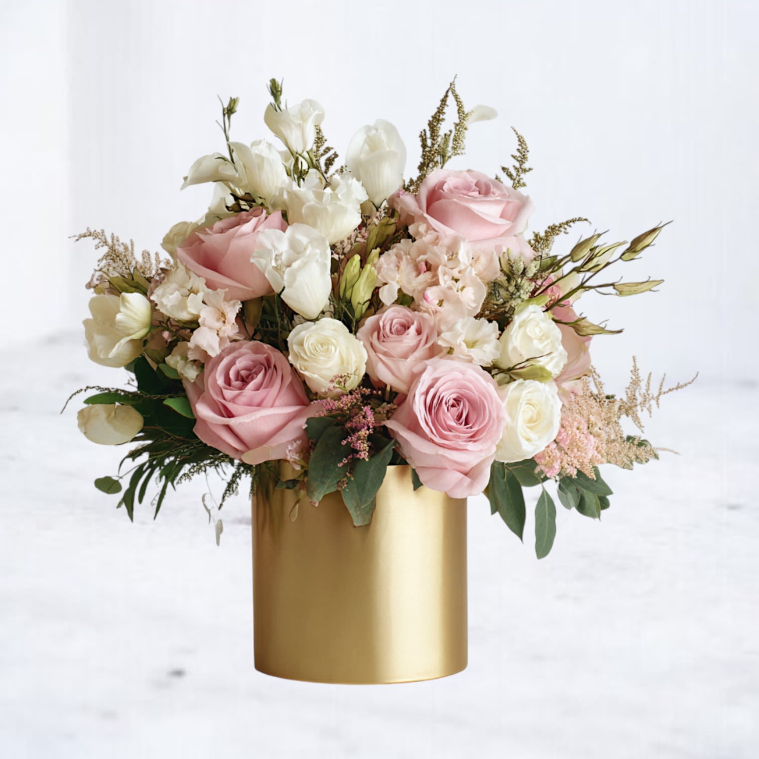 Doubloons - Doubloons is a softly composed arrangement inspired by the quiet beauty of gathered garden blooms. Blush and ivory roses are layered with delicate seasonal florals and fresh greenery, creating a design that feels warm, balanced, and effortlessly elegant. Styled in a refined gold vessel, this arrangement blends natural movement with thoughtful structure—lush without feeling heavy, romantic without feeling overly formal. Each Doubloons is designed with premium blooms selected for texture, longevity, and graceful flow.  Ideal for anniversaries, meaningful gestures, or everyday moments that call for something elevated and timeless.  Flower varieties may vary based on seasonal availability, but overall color palette, style, and fullness will be thoughtfully maintained.