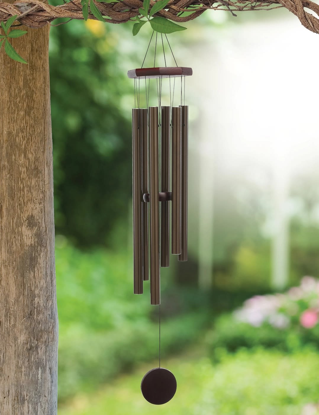 Peaceful Chime 42'' ~ Sunset Vista Designs - Aestheticism with functionality, the Peaceful wind chime from Sunset Vista Designs exudes a classical style in beauty and in tone. Handcrafted with anodized aluminum tubes, solid wood &amp; durable nylon braided cord. Six, deep bronze harmonizing tubes balance below the solid wood octagonal suspension platform. Each gentle breeze produces a blended tenor tone. The solid wood sail is blank so it can be personalized. Made with rust-resistant, anodized aluminum, wood &amp; durable nylon braided cord.  • Each tube provides a joyful resonating note. • Includes easy hanging metal hook. • Makes a great gift for any season or reason! • Measures approximately: 6.25" x 6.25" x 42"