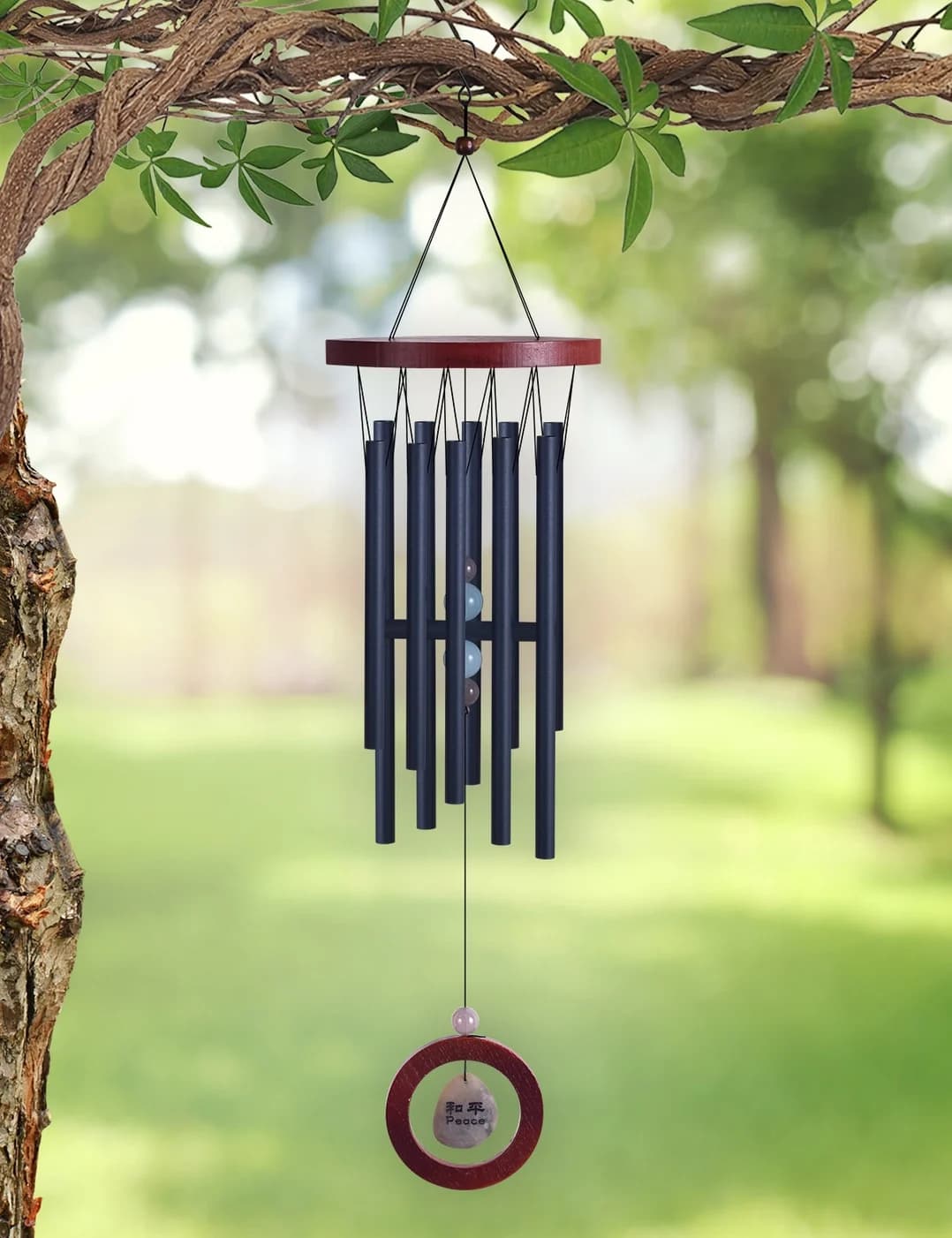 Peace Stone WInd Chime 28'' ~ Sunset Vista Designs - The Sunset Vista Designs Harmonious Peace Stone wind chime encourages peace &amp; prosperity. Crafted with durable wood and aluminum - a earthy brown wood topper above 10 black powder coated aluminum harmonious tubes, accented with color toned acrylic beads. The chime sounds of with the wooden ring surrounding the natural stone wind catcher with 和平 / Peace on the stone. Handcrafted / powder coated aluminum. • Features Natural Stone. • Includes easy hanging hook. • Solid wooden center clapper. • Perfect gift for the Feng Shui enthusiast! • Measure approximately: 6.75" x 3.5" x 28.5"