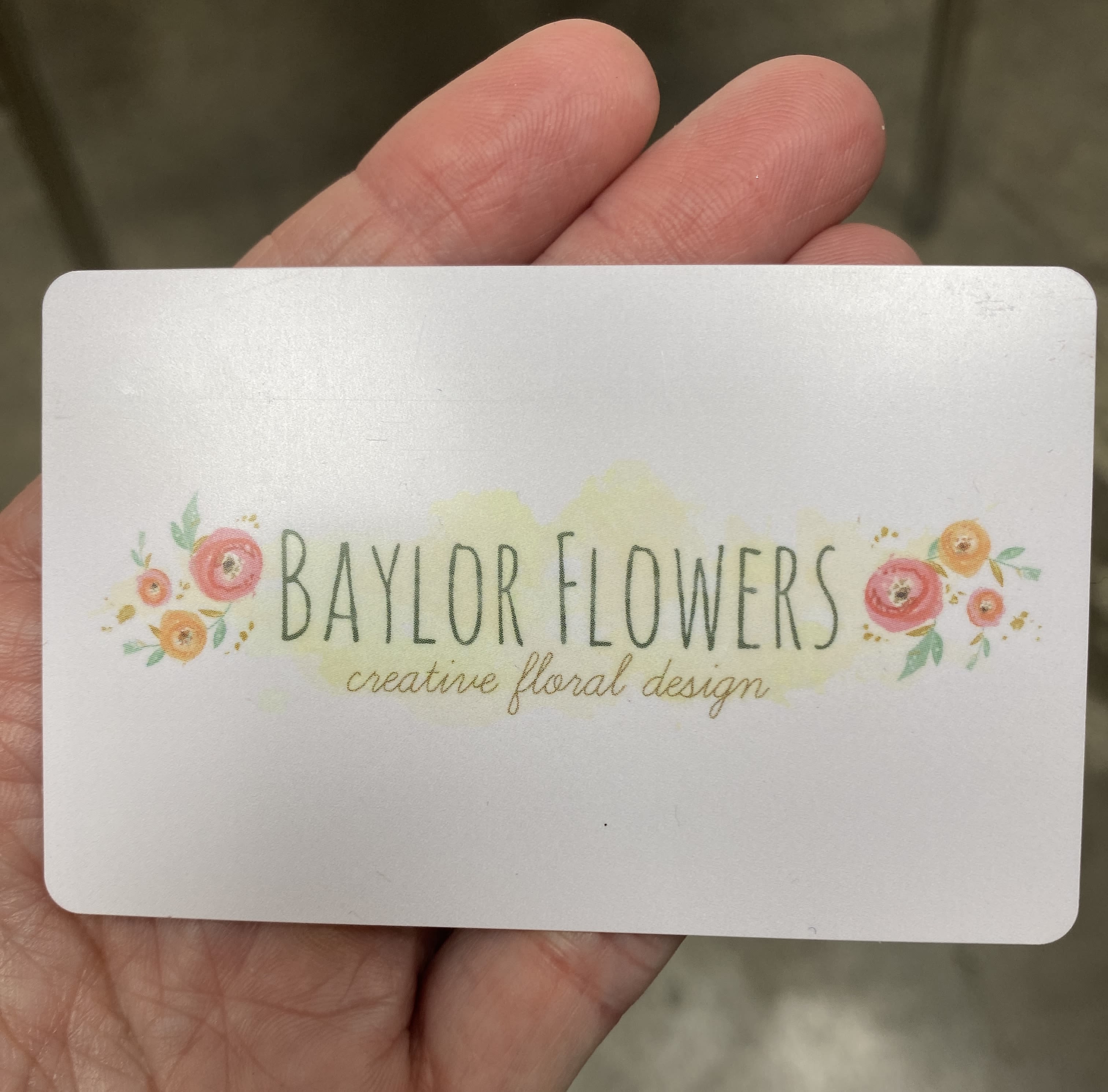 A business card reading Baylor Flowers with small floral illustrations
