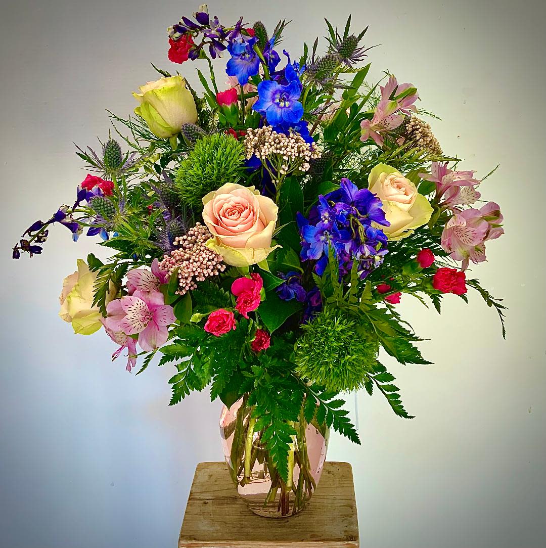 Spring Love  - Pink Roses and Blue Delphinium along with Pink Rice flower will thrill the new love in your life!  