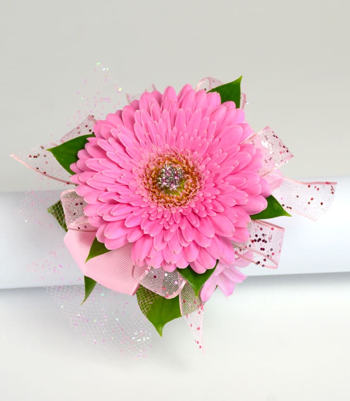 Pink gerbera daisy corsage with glitter and pink ribbons