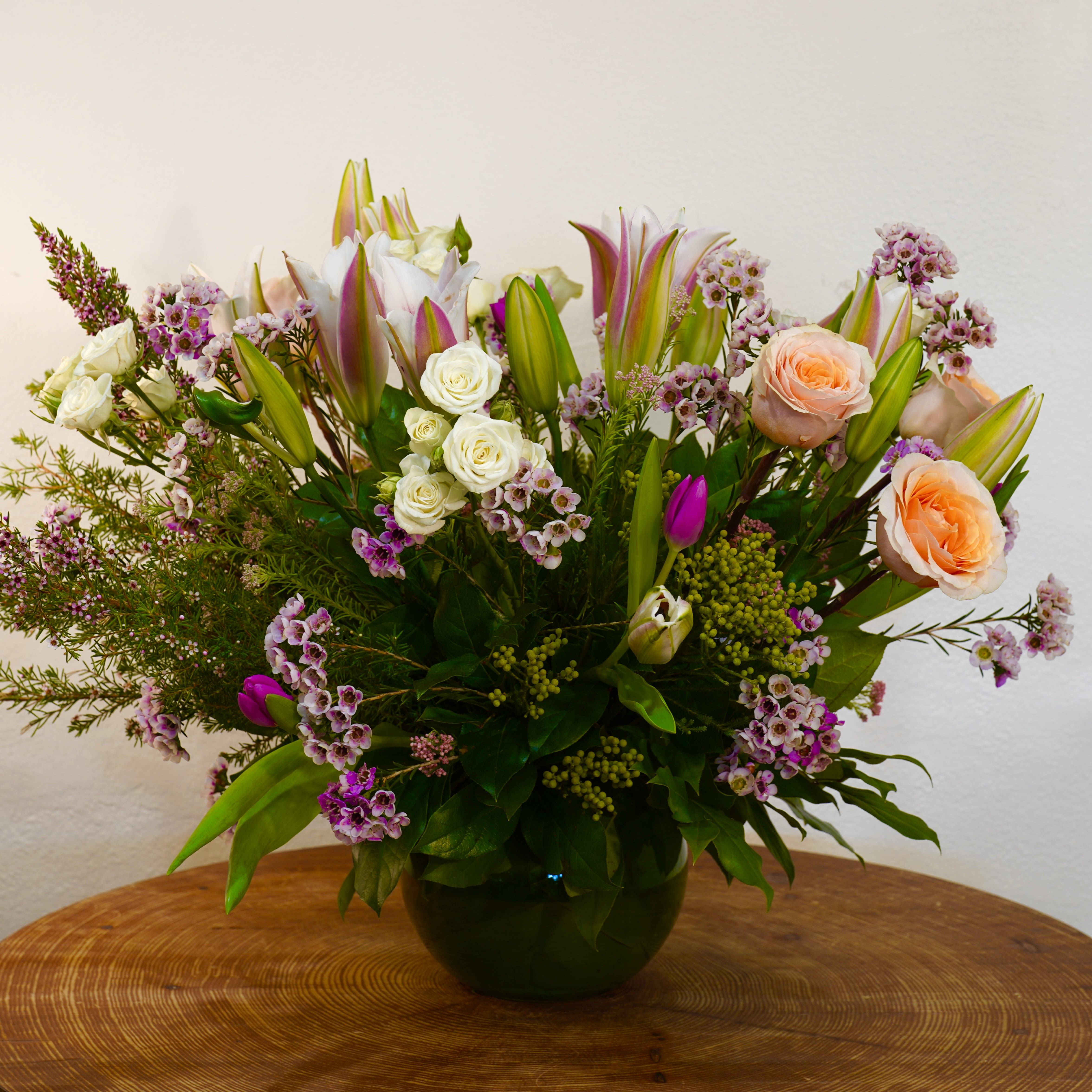 Garden Blossom - A stunning garden-style floral arrangement featuring elegant lilies, roses, tulips, and seasonal blooms arranged with fresh greenery. This vibrant design brings color, beauty, and natural charm to any home or celebration and makes a perfect gift for someone special. Handcrafted with care by Guy Floral Studio. We offer same-day flower delivery in Beverly Hills, West Hollywood, Santa Monica, Beverly Grove, Bel Air &amp; Culver City. Order online or call now for fast delivery today. The arrangement shown in the photo reflects our Deluxe size, featuring a fuller, more abundant design with premium blooms. 