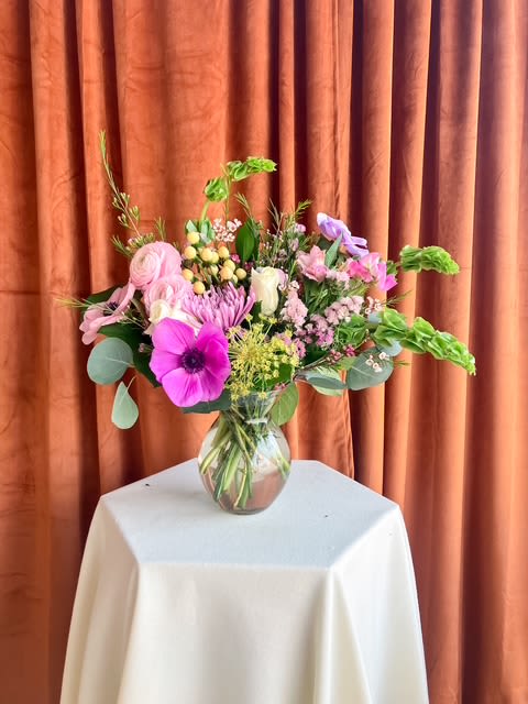 Spring Palette  - A joyful expression of the season, Spring Palette is designed like a living work of art. This arrangement brings together a curated mix of premium blooms and textural elements, creating movement, depth, and a naturally gathered feel. Inspired by the colors of early spring and the beauty of a blooming meadow, each design is thoughtfully composed in a modern glass vase, allowing every stem to shine.