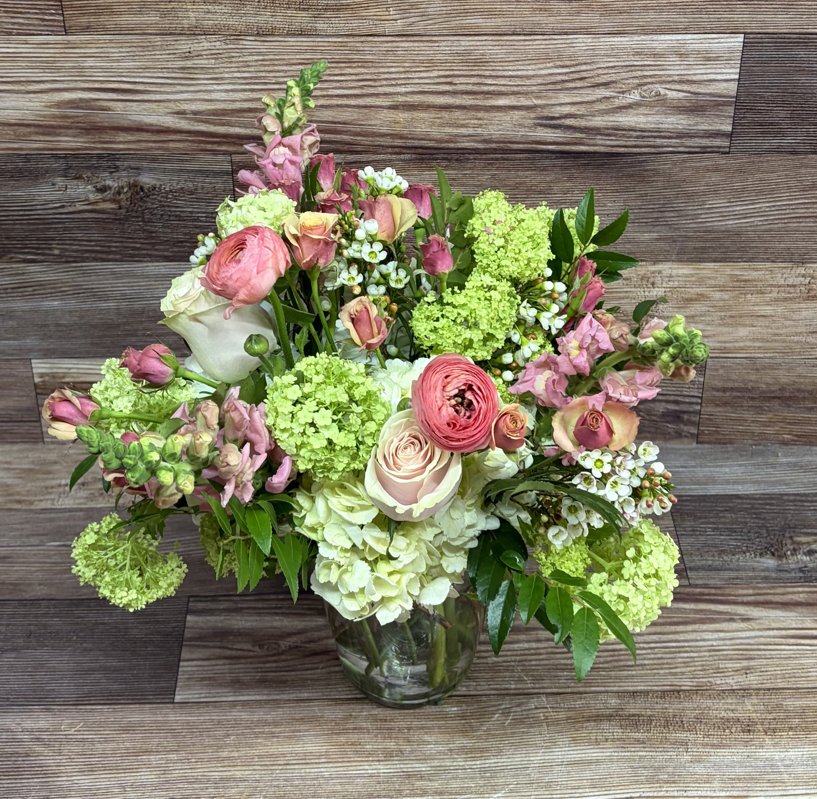 Spring Viburnum and Pinks - green viburnum, white hydrangeas and a varierty of spring pinks in a 7.75" X 6.75" tapered vase.