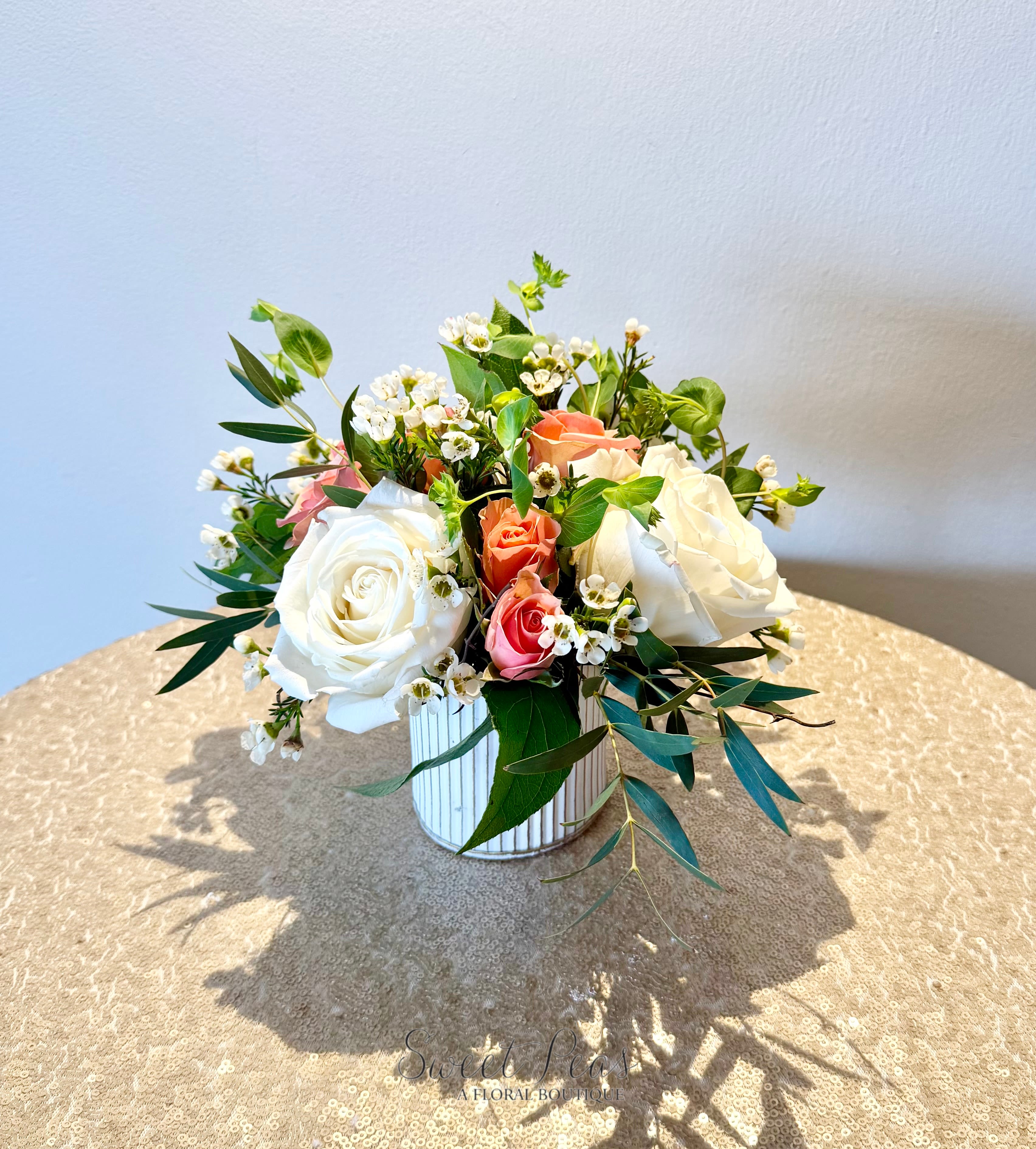 Blush and Ivory Garden - Timeless and graceful, Blush &amp; Ivory Garden features a delicate blend of creamy white and soft blush roses accented with airy wax flower and fresh greenery. Designed in a classic white vessel, this arrangement offers a light, romantic feel with natural movement and texture. Perfect for anniversaries, sympathy, or simply sharing a thoughtful gesture, it’s an effortlessly elegant design that suits any occasion.