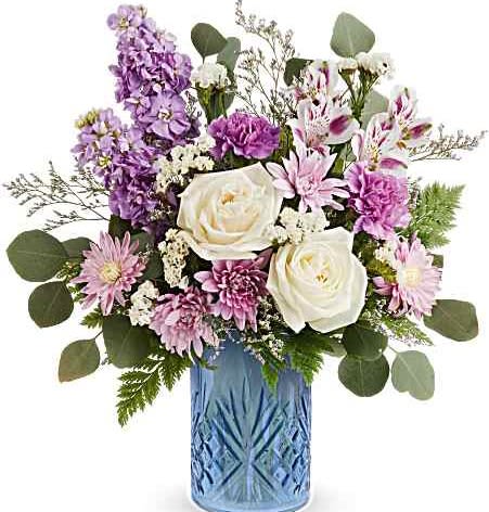 Teleflora's Blue Bliss Bouquet - Delight Mom with Teleflora's Blue Bliss Bouquet, a fresh mix of white and lavender blooms beautifully arranged in Teleflora's Blue Belle Vase. This elegant Mother's Day gift brings soft color, charm, and lasting beauty to her home.
