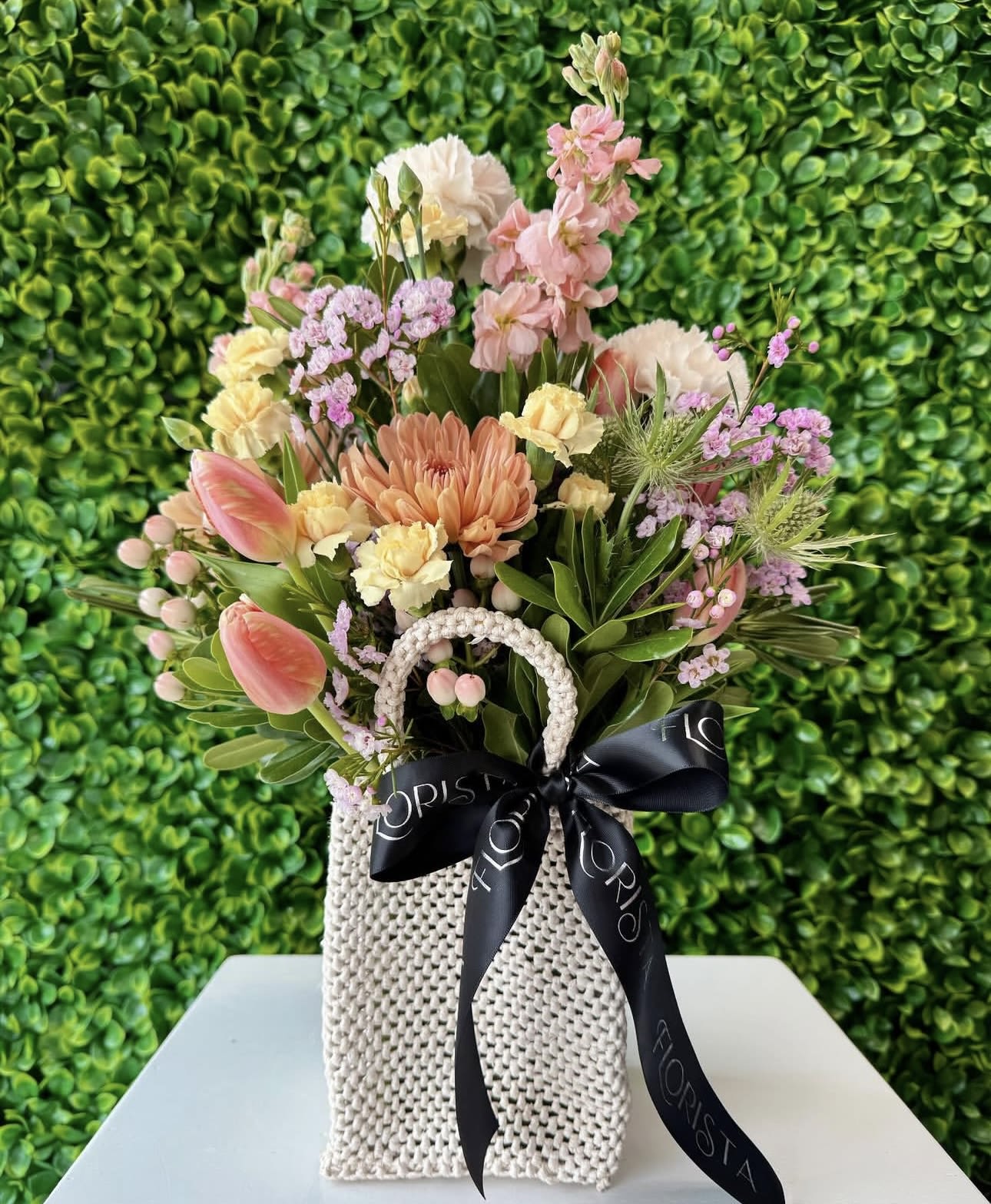 THE BLOOM BAG - A unique gift for Mother's Day featuring a white woven bag filled with gorgeous blooms. The perfect way to show mom how much you love her. 