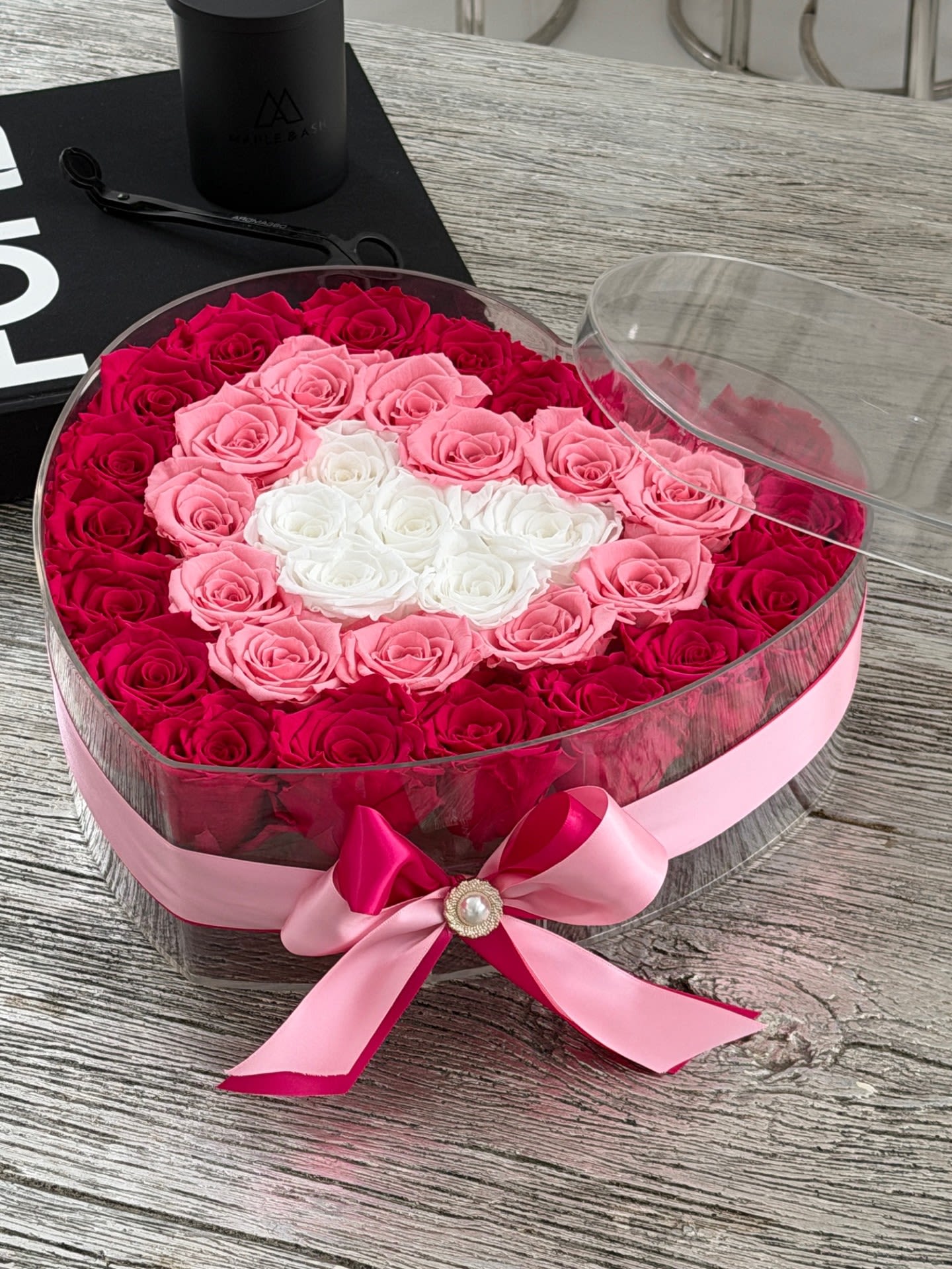 Blushing Heart - Soft, romantic, and beautifully detailed, this heart-shaped arrangement features premium preserved roses in shades of red, blush pink, and ivory. Designed with a layered color palette and finished with an elegant ribbon, it creates a delicate yet striking statement of love. Each rose is preserved to maintain its beauty for years, making it a timeless gift perfect for anniversaries, special occasions, or heartfelt moments.