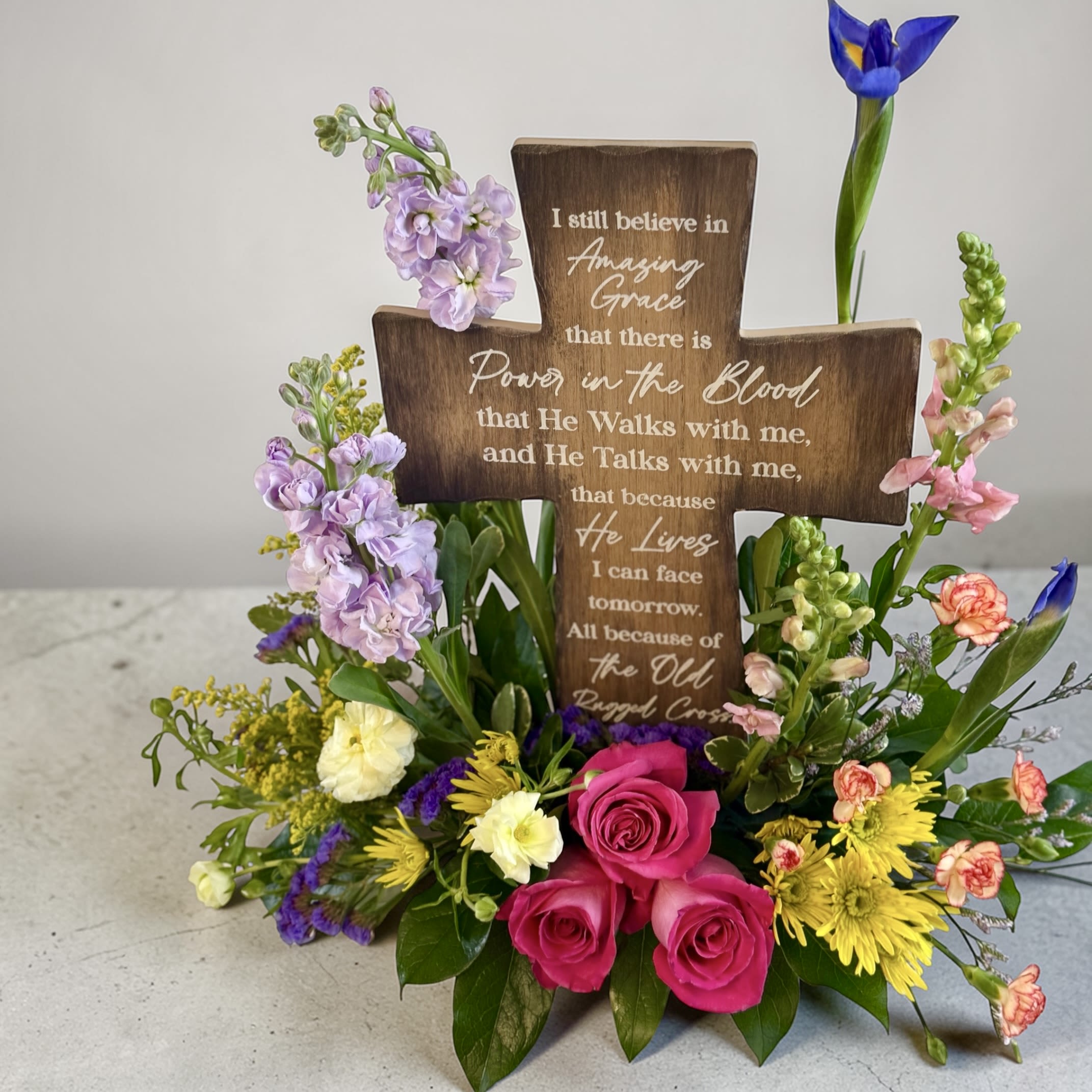 The Rugged Cross - A beautifully arranged Easter cross, complimented by spring flowers.