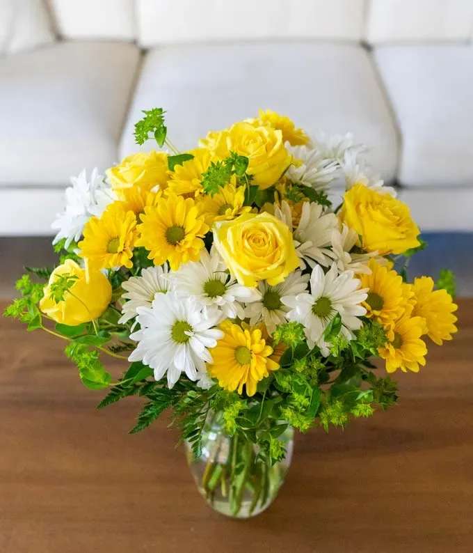 Sunny Smiles - They won’t have to wonder if you love them or love them not when you send this charming bouquet! Showcasing vibrant yellow and white daisies, and roses it’s a sweet surprise that lets them know just how much you care