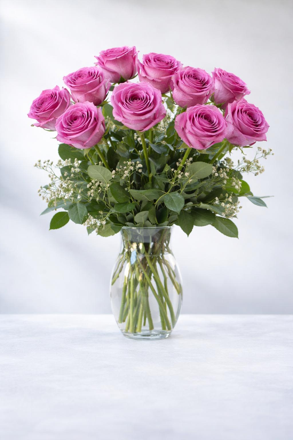 Lavender Rose Bouquet - Nothing speaks of love so much as a bouquet of beautiful roses. Arranged in a classic glass vase, this bouquet is a gift to her heart from yours. Standard rose bouquet includes 12 stems, approximately 18"H x 12"W, Deluxe rose bouquet includes 18 stems, approximately 19"H x 16"W, premium rose bouquet includes 24 stems, approximately 20"H x 18"W. 